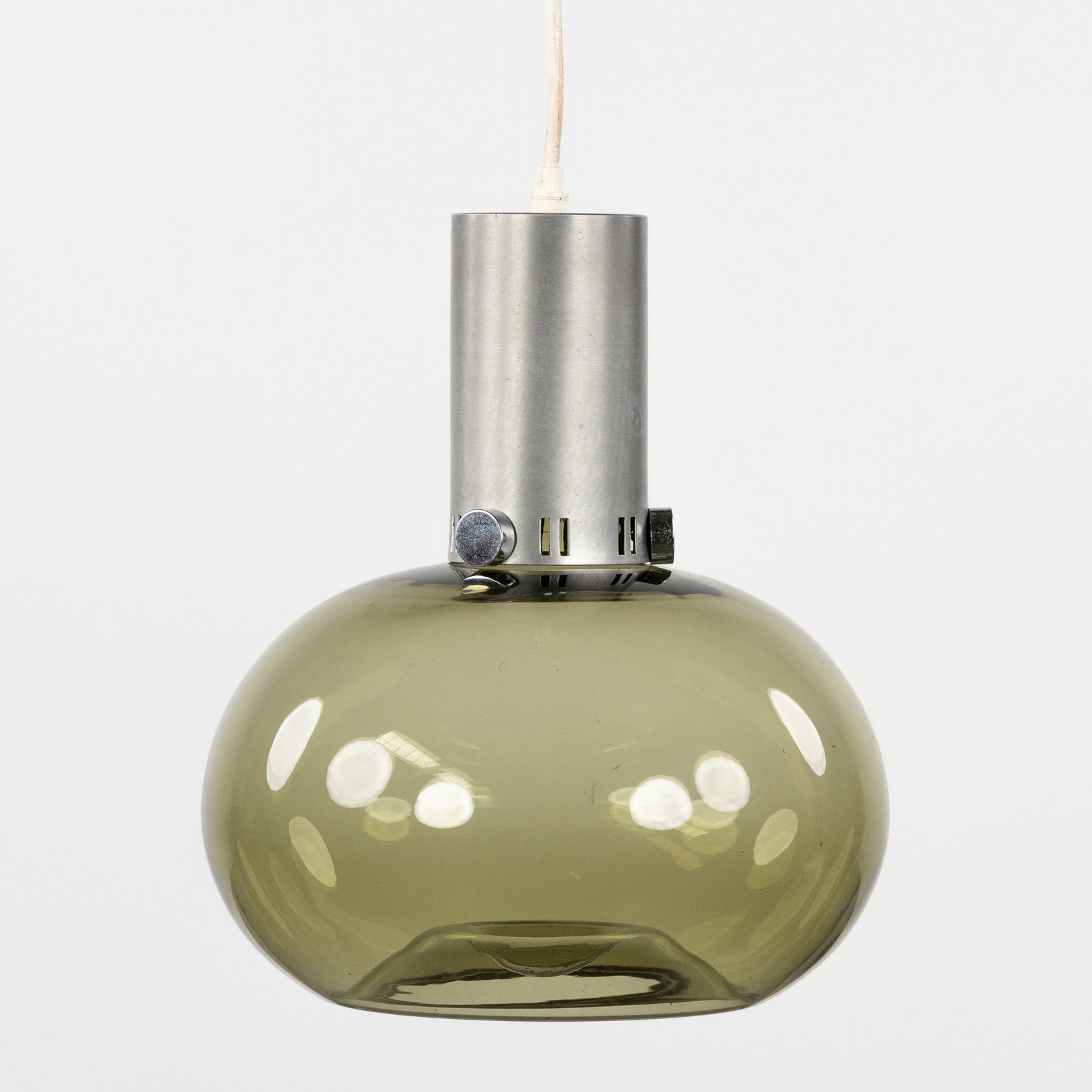 Raak Amsterdam, a mid-century pendant lamp. Chromed metal and glass. Circa 1960.: Raak Amsterdam, a mid-century pendant lamp. Chromed metal and glass. Circa 1960. Labeled 'RAAK Amsterdam - Made in, Holland'.Height including cable/cord: 105 cm. Dimensions: (W:29 x H:34 cm) The absen