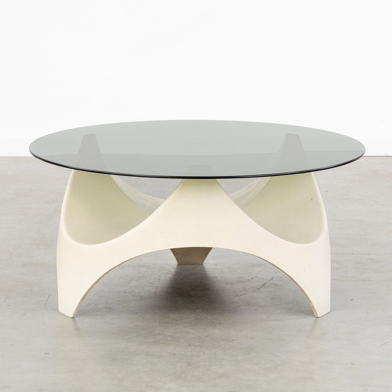Opal Möbel, a Mid-Century 'Space Age' coffee table, fiberglass and glass, Germany, circa 1970.: Opal Möbel, a Mid-Century 'Space Age' coffee table, fiberglass and glass, Germany, circa 1970. Patinated fiberglass and tinted glass.Unmarked. Dimensions: (W:90 x H:42,5 cm) The absence of a conditio