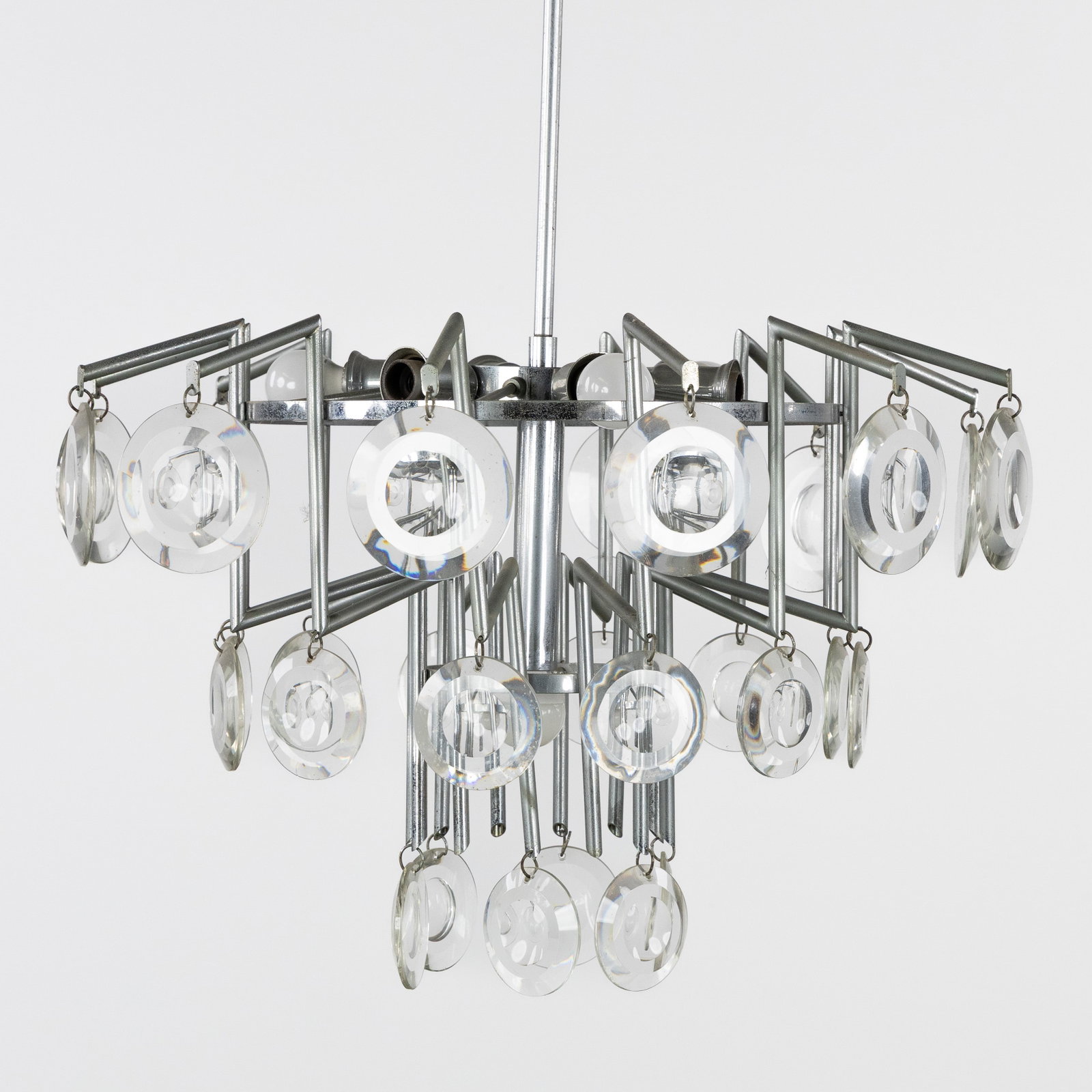 A 'Spage Age' Chandelier with glass plaques, chrome-plated metal and glass, circa 1970.: A 'Spage Age' Chandelier with glass plaques, chrome-plated metal and glass, circa 1970. Chrome-plated metal and glass.7 light points and 30 plaques.In the style of Carlo Nason, Gaetano Sciolari, and O