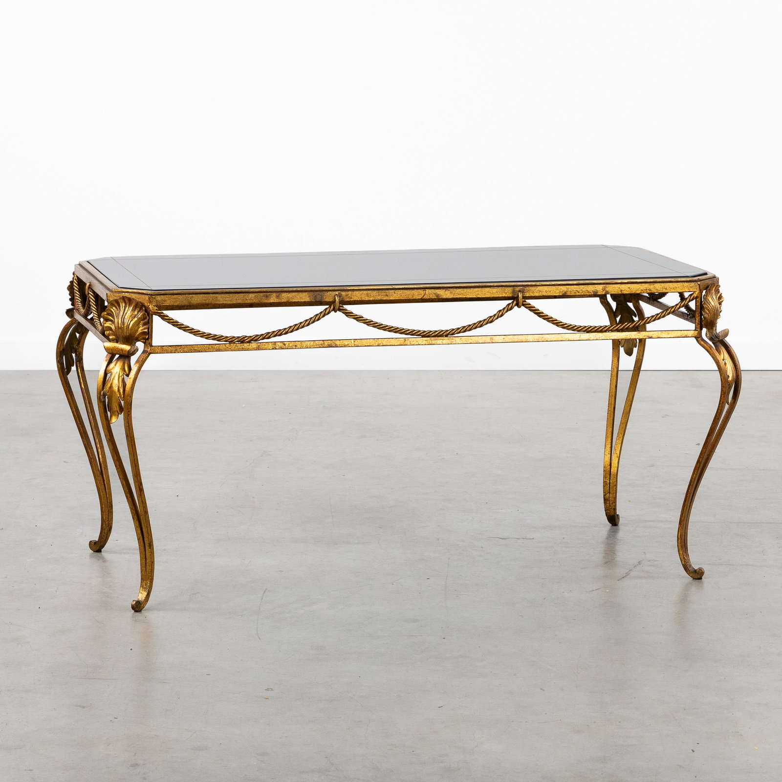A Hollywood Regency coffee table, gilded wrought iron and black mirror glass, circa 1940. (1 of 7)