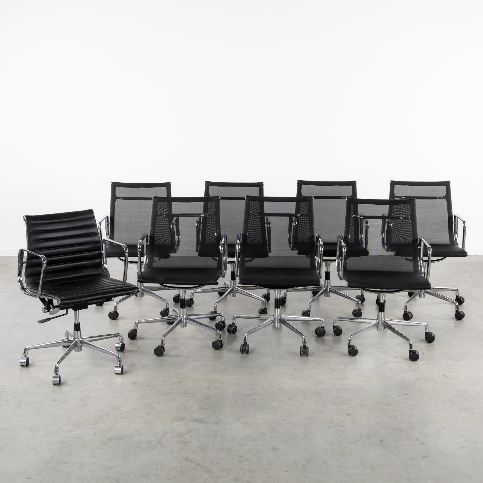 A Set of 7 + 1 Office chairs, in the style of Charles & Ray Eames. (1 of 9)