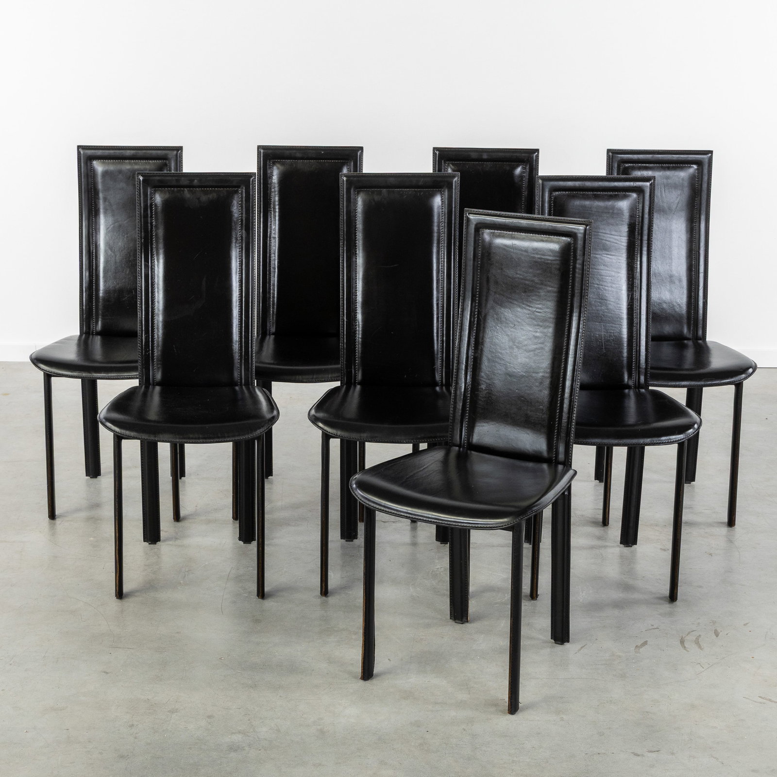 A Set of 8 black leather high chairs, in the style of Giorgio Cattelan, Italy, circa 1980. (1 of 5)