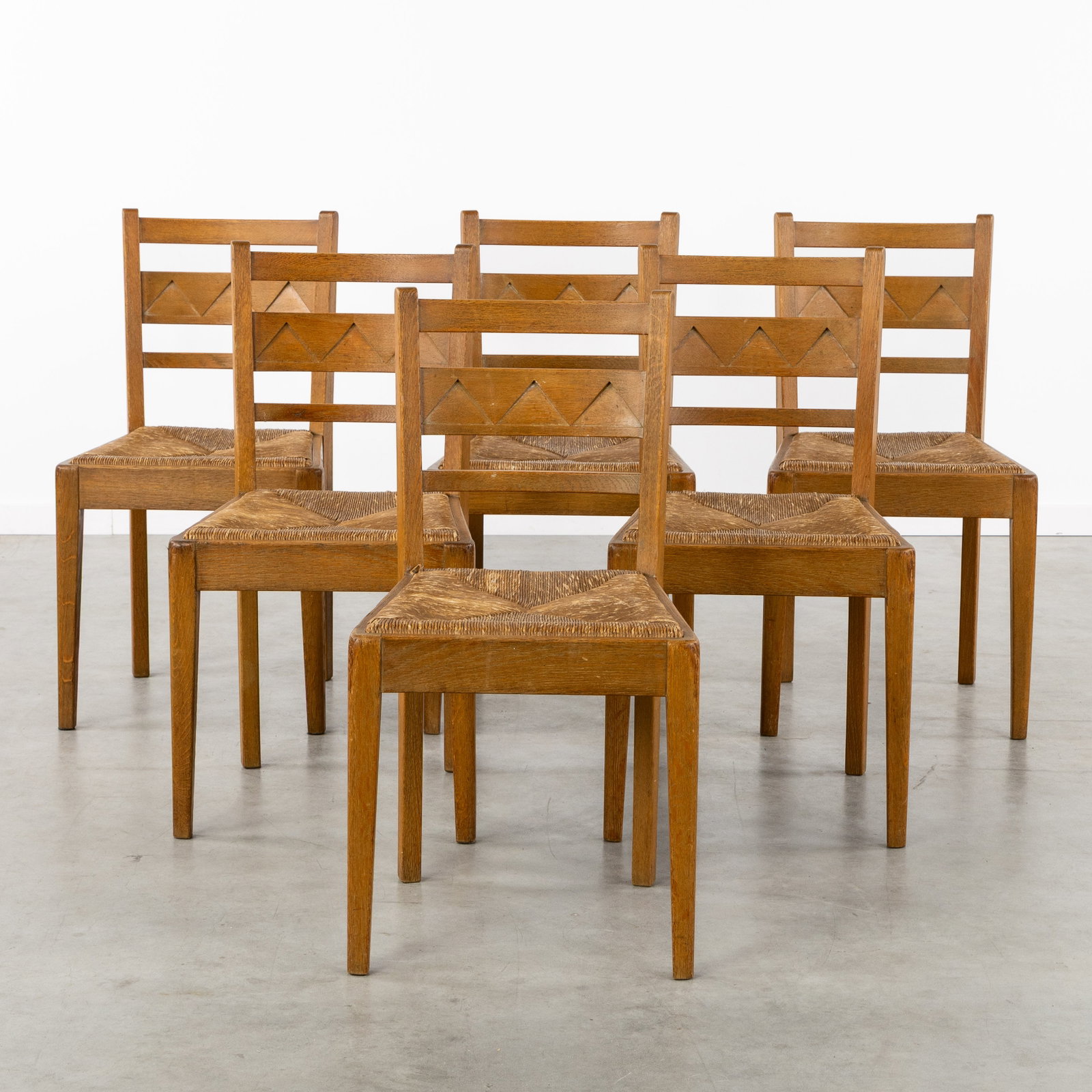 A Set of 6 Brutalist chairs with rush seats, sculptured oak, circa 1960. (1 of 4)
