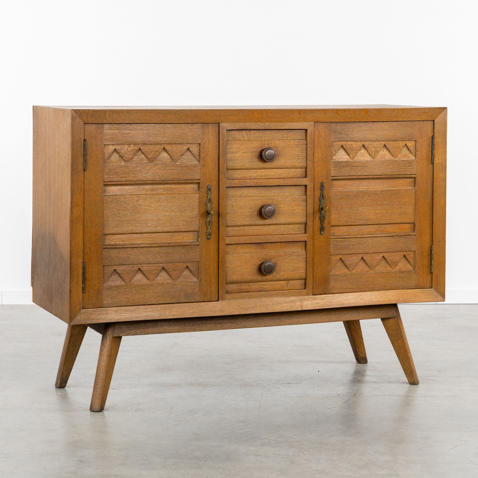 A Brutalist dresser or sideboard, Sculptured oak, circa 1960. (1 of 9)