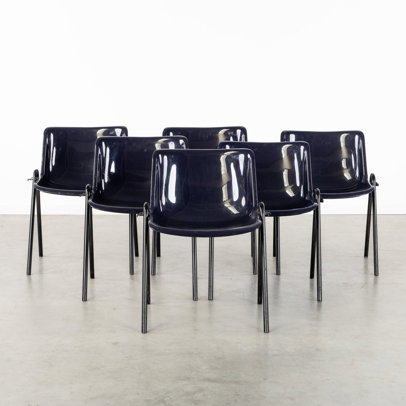 Osvaldo Borsani (1911-1985) 'Modus SM 203', a set of six stackable chairs, for Tecno, Italy, circa: Osvaldo Borsani (1911-1985) 'Modus SM 203', a set of six stackable chairs, for Tecno, Italy, circa 1990. Dark blue plastic and black lacquered metal.Model Modus SM 203.Designed by Osvaldo Borsani in 1