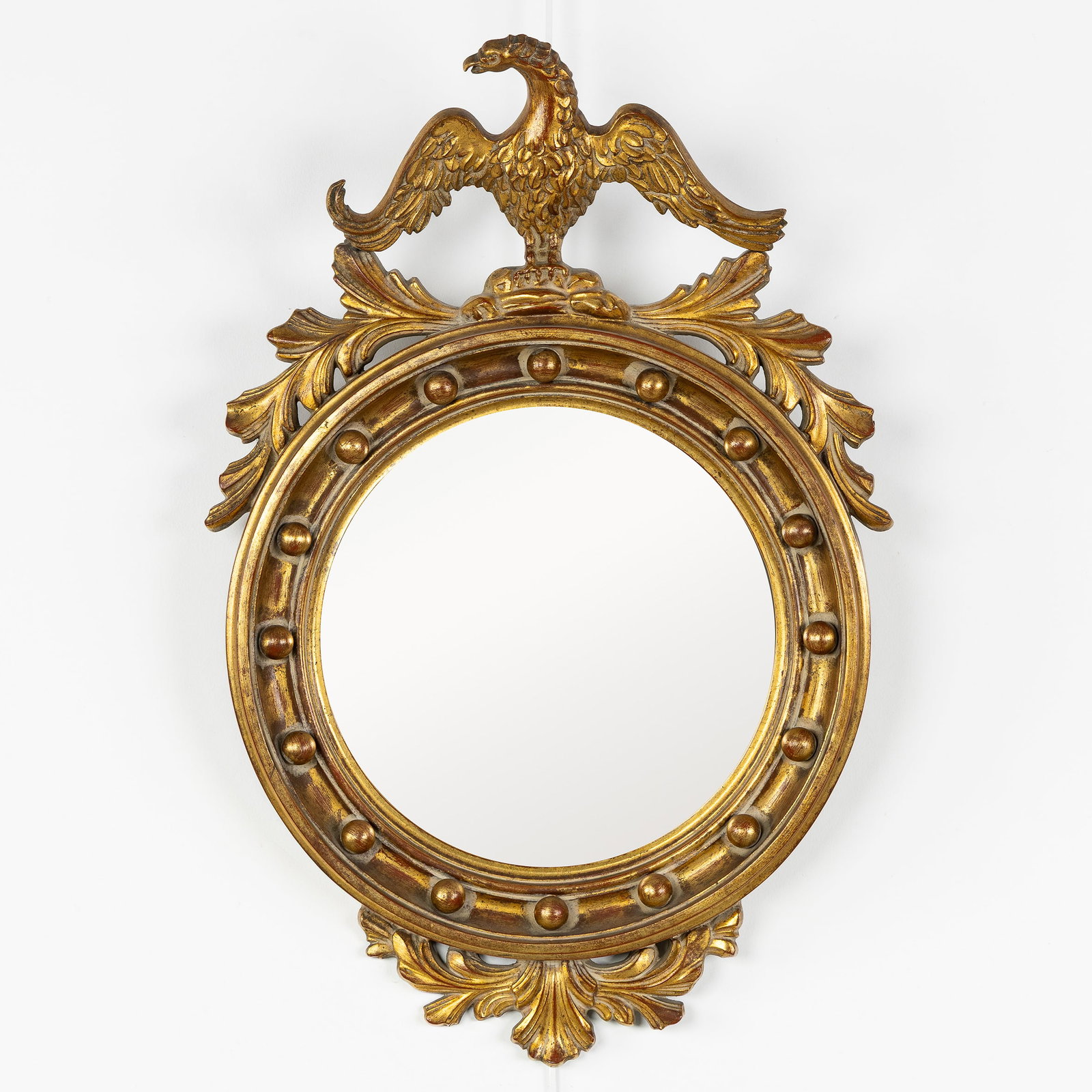 Deknudt, a mirror in Hollywood Regency style, finished with an eagle. Convex glass. Circa 1980. (1 of 4)