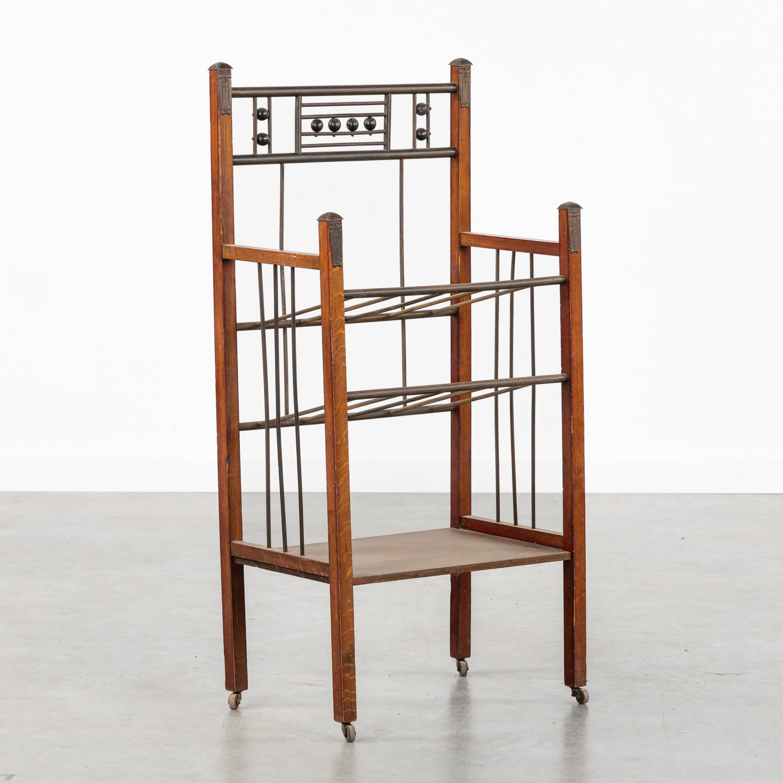 An Art Deco newspaper or magazine rack, wood and patinated metal, in the style of Ernst Rockhausen, (1 of 7)