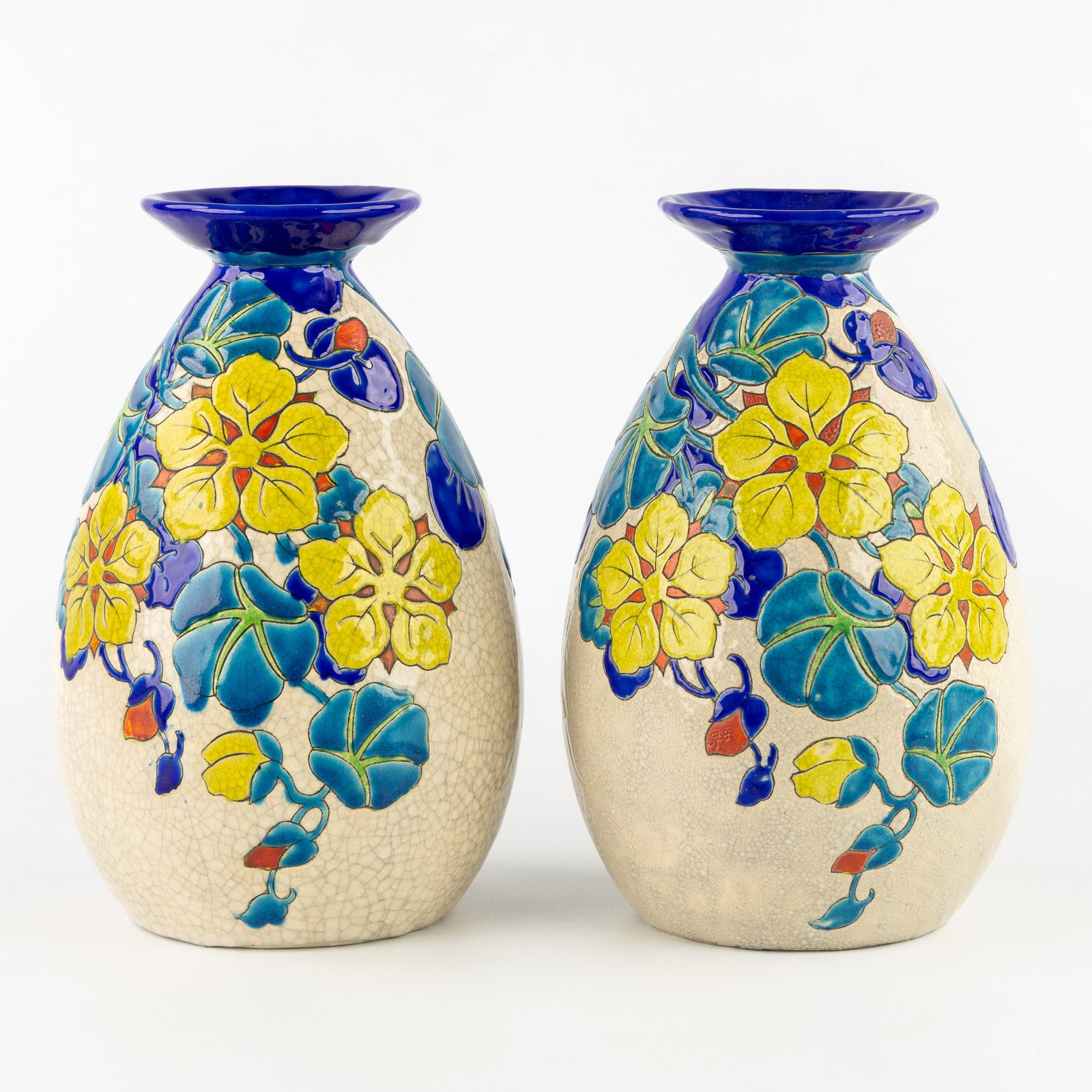Charles Catteau (1880–1966) ‘Pair of Vases', glazed ceramics for Boch Keramis.: Charles Catteau (1880–1966) 'Pair of Vases', glazed ceramics for Boch Keramis. 'Polychrome design with floral motives, orange and light blue on ivory base.' Model 945, decor 2762. Marked Boch Freres
