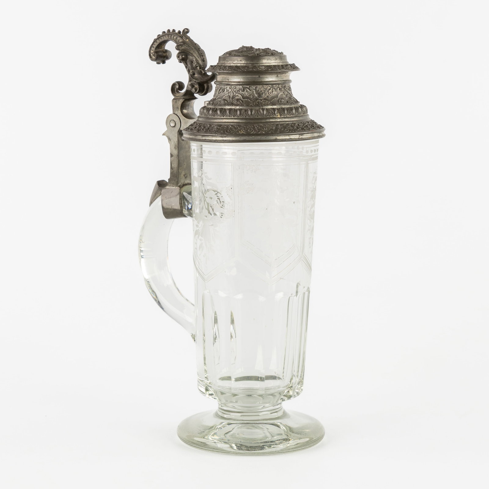 A crystal and pewter 'Beer Stein', Germany. 19th C.: A crystal and pewter 'Beer Stein', Germany. 19th century. Etched crystal with a floral decor. Mounted with a pewter lid and handle. The handle nicely finished with decorations in a Renassance Revival 