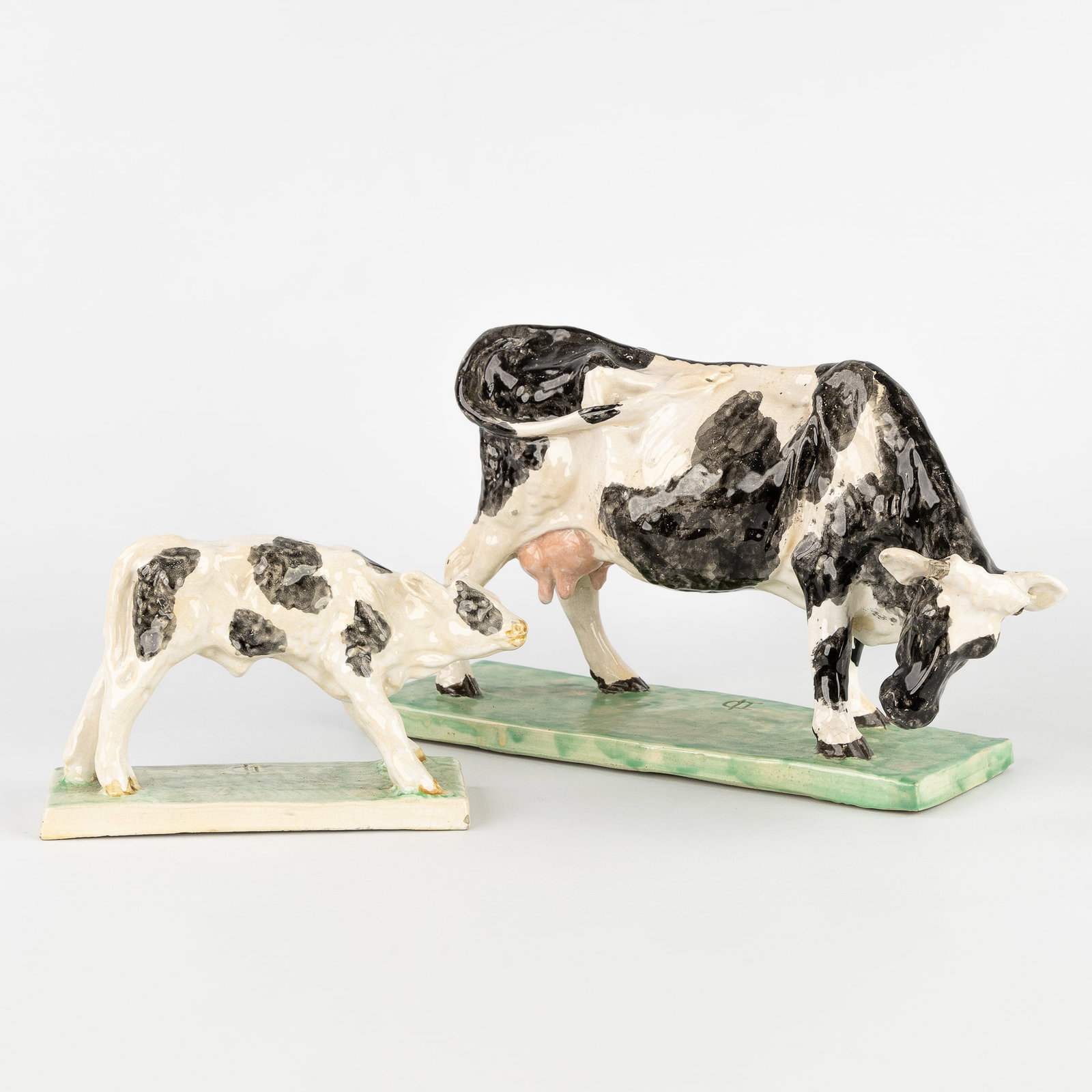 Domien Ingels (1881-1946) 'Cow' and 'Calf', two sculptures in glazed ceramics.: Domien Ingels (1881-1946) 'Cow' and 'Calf', two sculptures in glazed ceramics. Polychrome glazed ceramics.Monogrammed.Cow (H: 21 cm x W: 38 cm x D: 15 cm).Calf (H: 13 cm x W: 23 cm x D: 8 cm). Dimensi