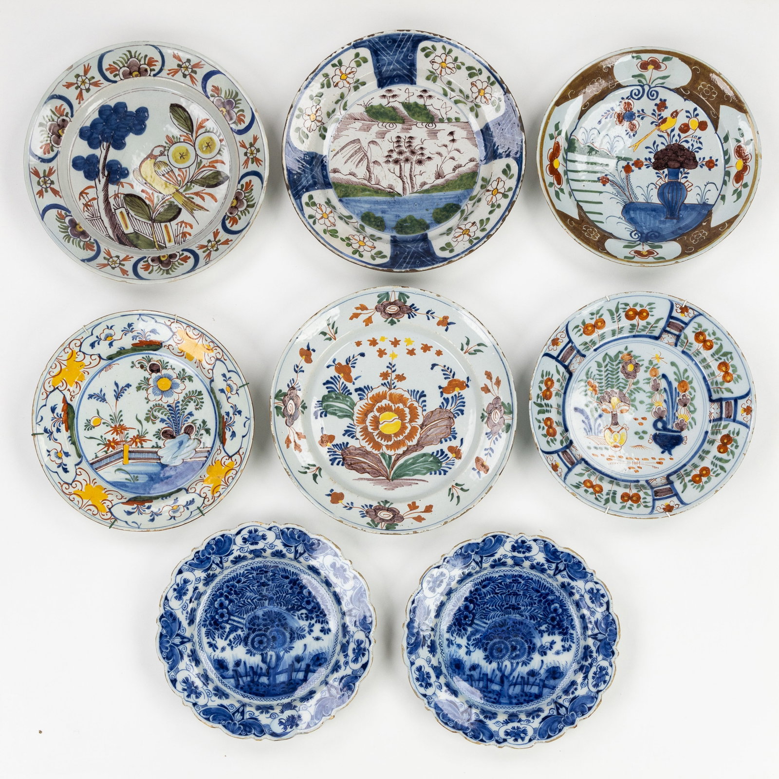 Eight Delft plates, Blue and White and Polychrome Delft earthenware, 18th C. (1 of 3)