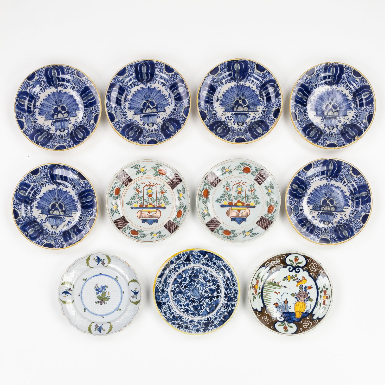 Ten Delft plates, Peacock Tail and other decors, Blue and white and Polychrome Delft earthenware,: Ten Delft plates, Peacock Tail and other decors, Blue and white and Polychrome Delft earthenware, 18th century. Delft earthenware, blue and white.Six plates with Peacock Tail decoration, marked for De