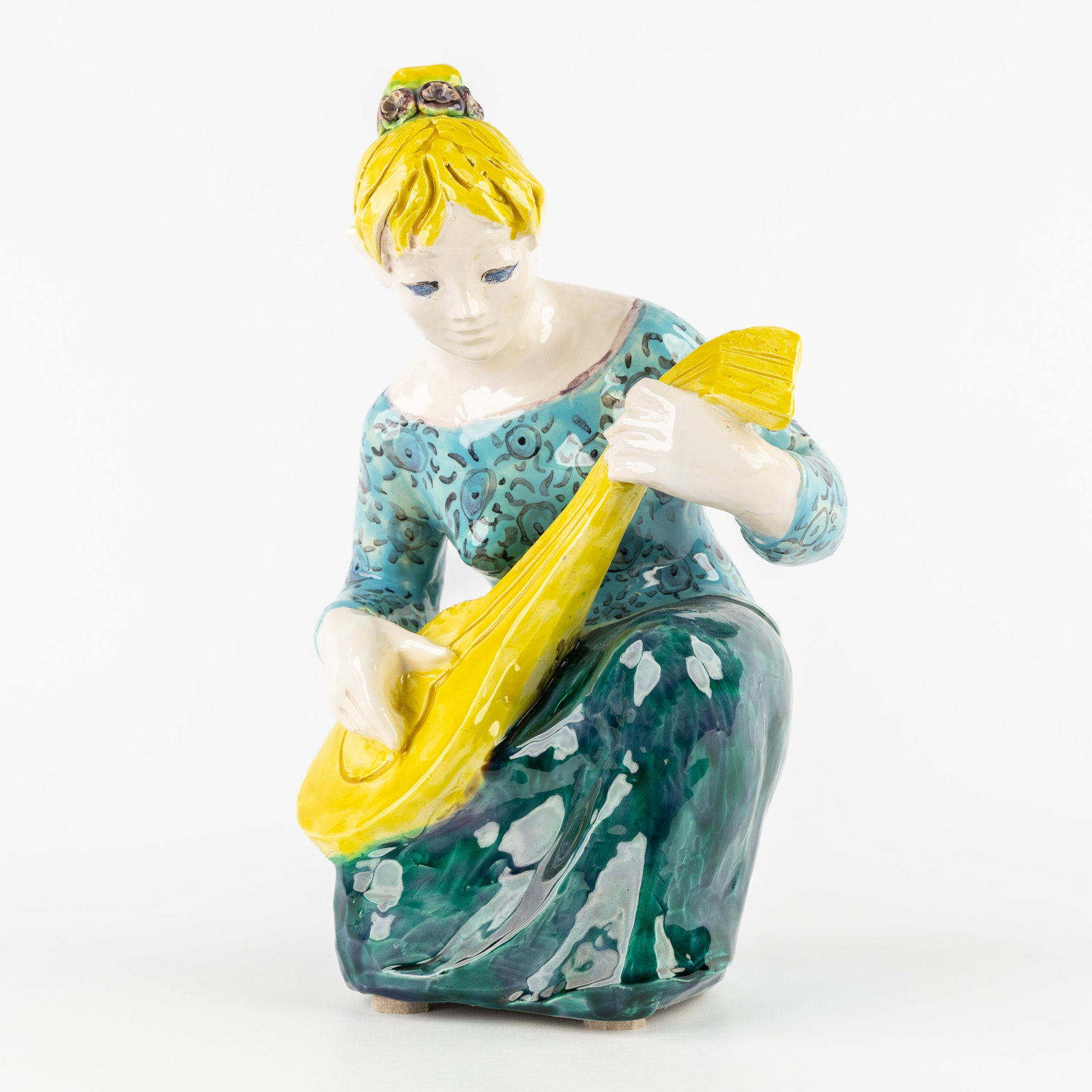 Odette Lepeltier (1914–2006) 'The Lute Player', glazed ceramic.: Odette Lepeltier (1914–2006) 'The Lute Player', glazed ceramic. Marked on the lower rim. Dimensions: (W:19 x H:30 x L:16 cm) The absence of a condition report does not imply a perfect item. Please s