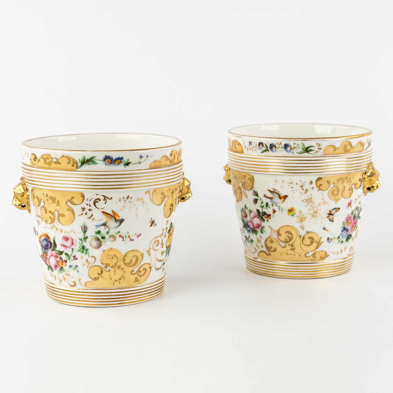 A Pair of porcelain Cache-pots or Planters, with hand-painted floral decoration and lion's heads, (1 of 10)