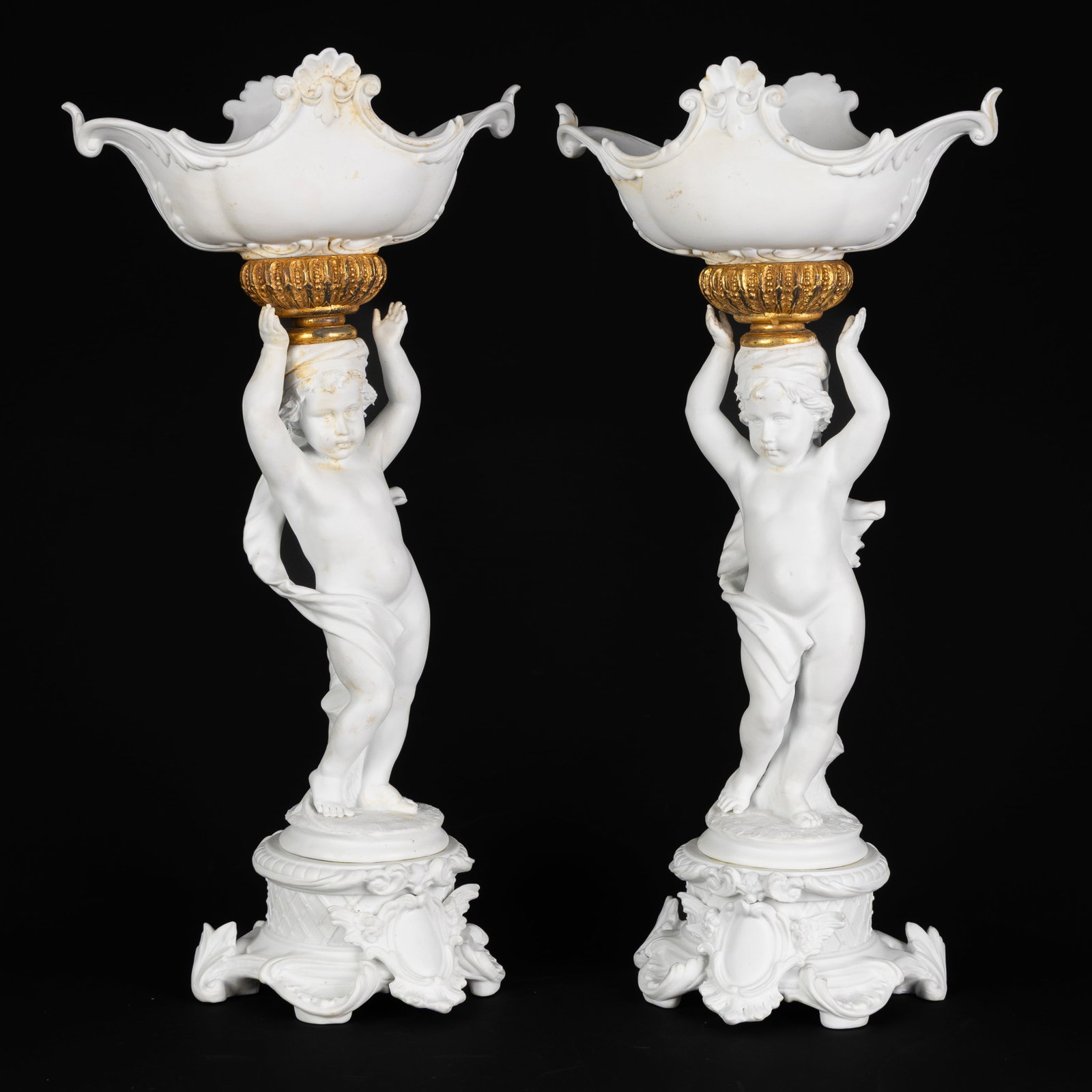 A Pair of Centerpieces or 'Milieu-de-Tables', Putti with a Bowl, biscuit porcelain and gilded brass, (1 of 10)