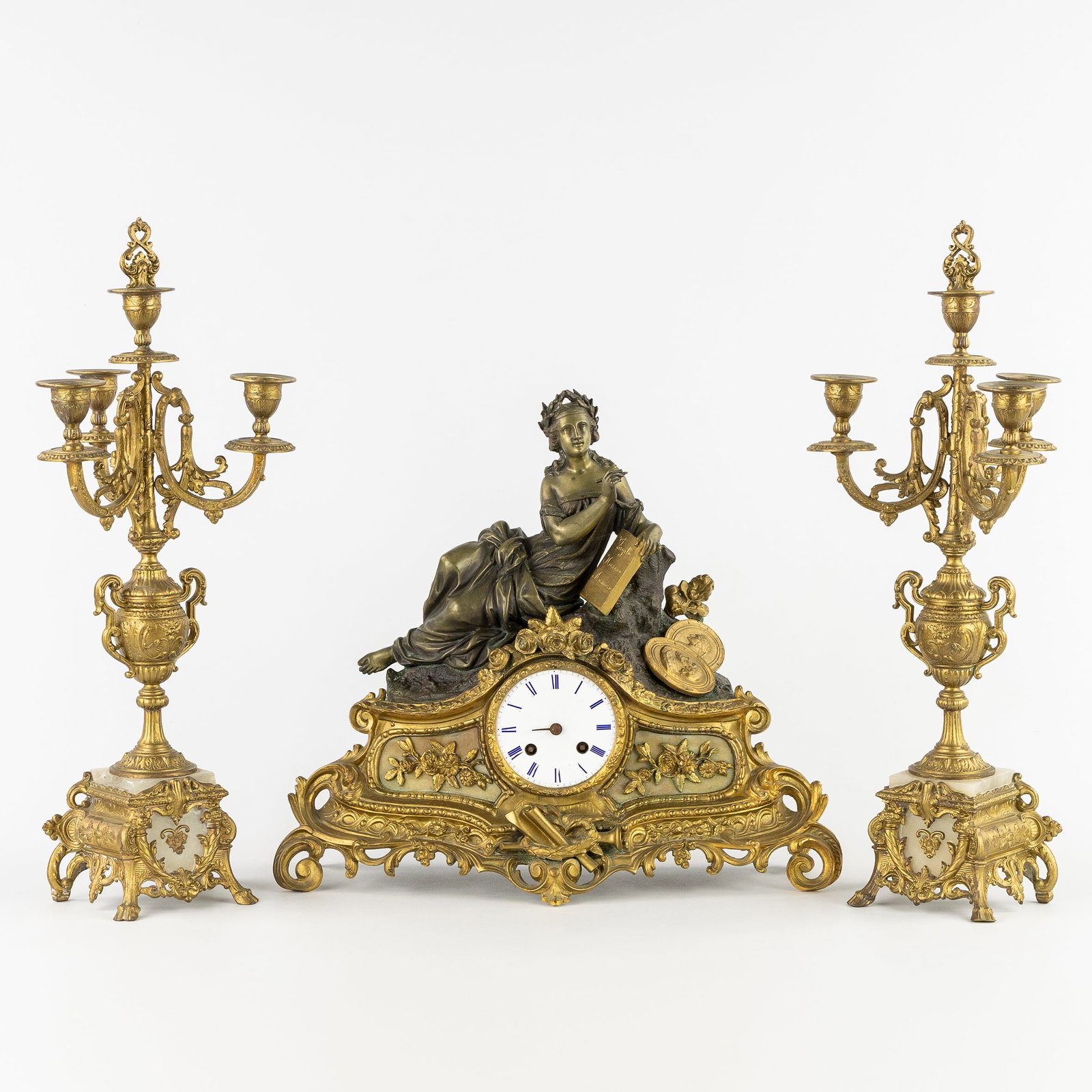 A Three-piece mantel garniture, Calliope, Muse of Poetry, clock and candelabra, gilded and patinated (1 of 11)