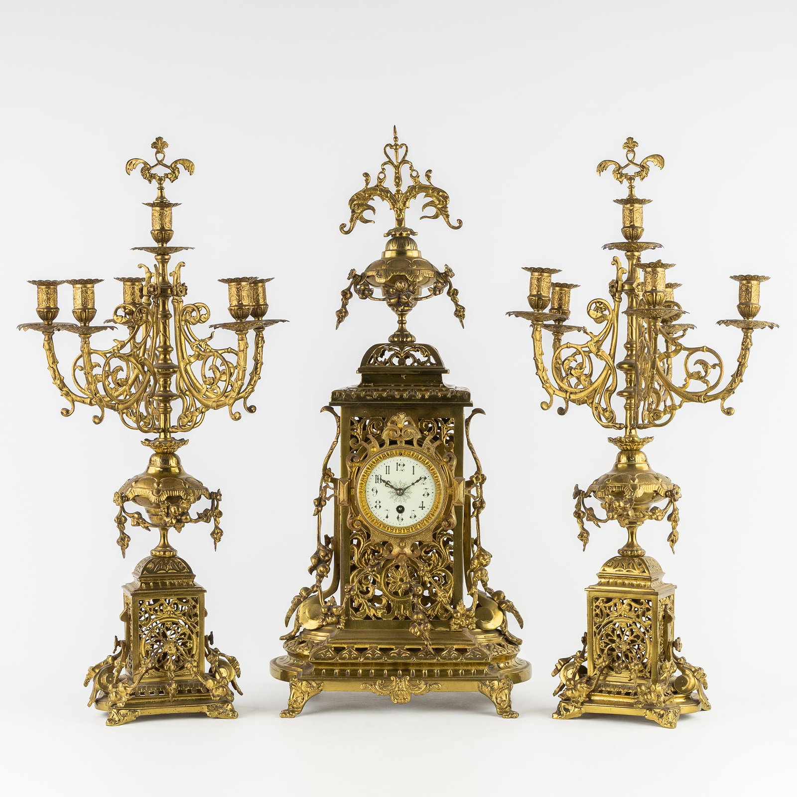 A three-piece mantelpiece set, decorated with dolphins and garlands, featuring a clock and (1 of 11)