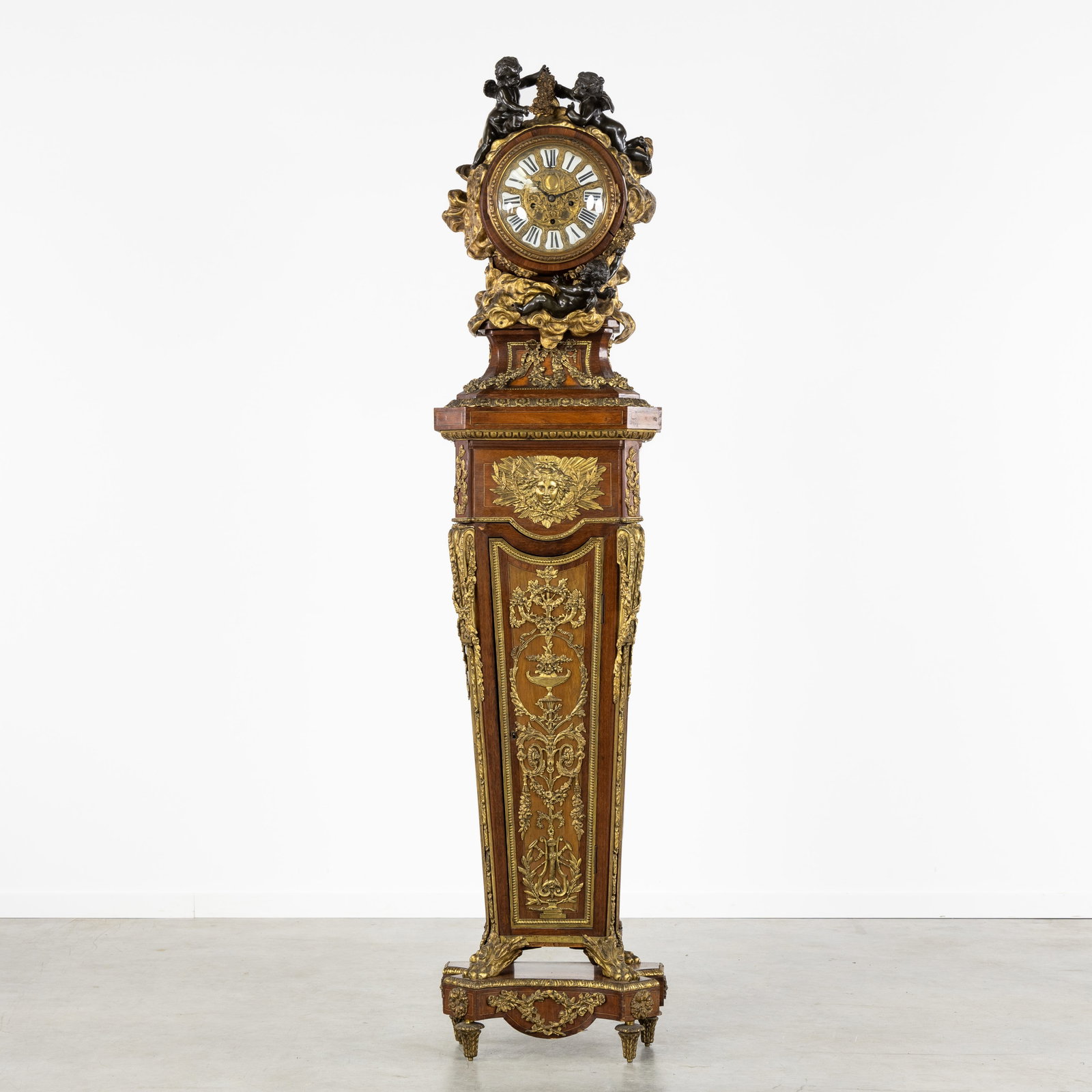 An Exceptional grandfather clock, richly decorated with gilded bronze and putti, after Jean Henri (1 of 13)