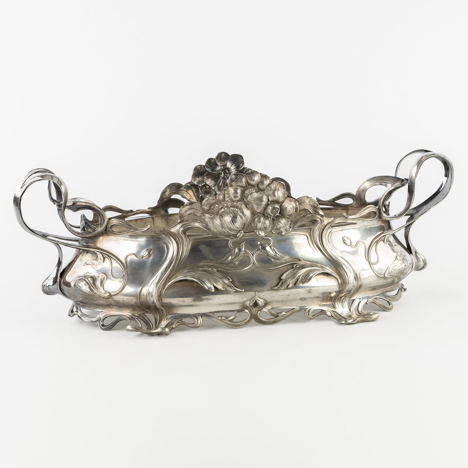 A large jardinière, silver-plated tin and glass, Art Nouveau. Circa 1900.: A large jardinière, silver-plated tin and glass, Art Nouveau. Circa 1900. A large jardinière, decorated with flowers and typical Art Nouveau style features. Mounted inside with a glass bowl. Circa 1