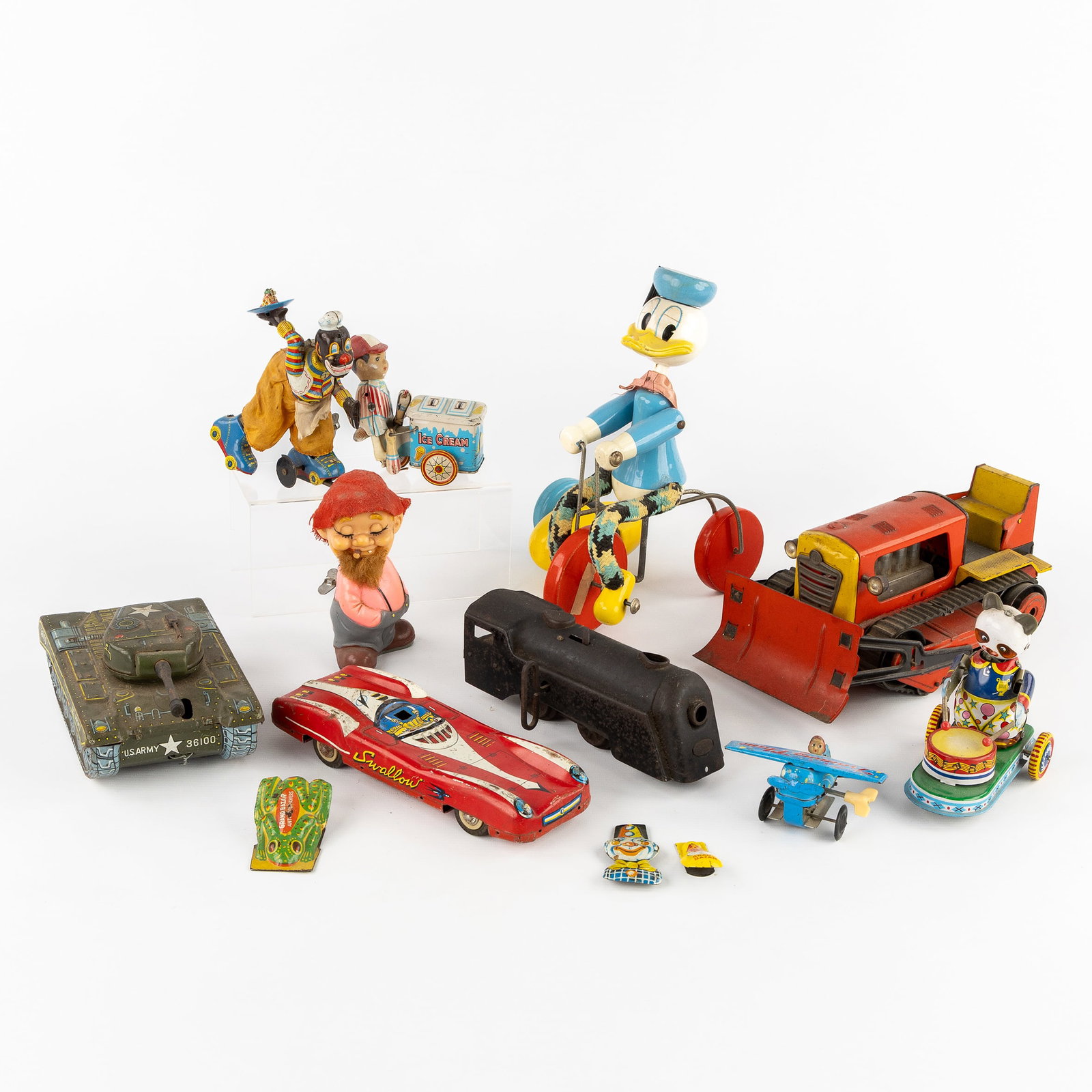 A Collection of 13 tin automata and toys. Japan, Germany, China, and France, circa 1950-1970.: A Collection of 13 tin automata and toys. Japan, Germany, China, and France, circa 1950-1970. Tin, wood, and plastic. ALPS, Happy Hobo, wind-up Hillbilly toy, Japan.TPS, roller skating clown, wind-up,