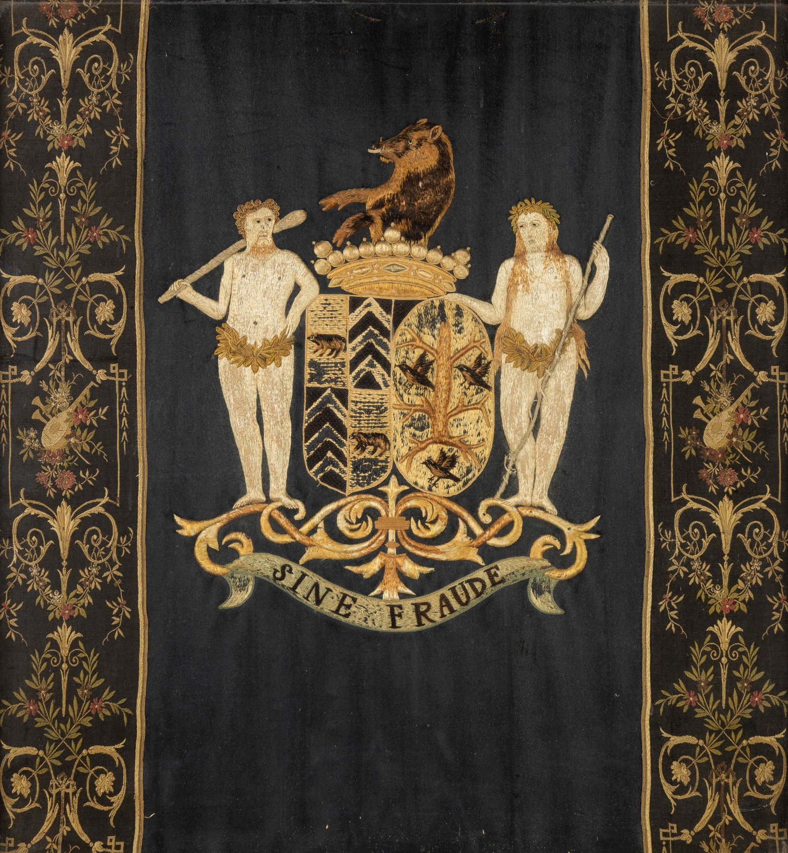 An embroidered coat of arms for the 'Van de Werve de Schilde' family, framed.: An embroidered coat of arms for the 'Van de Werve de Schilde' family, framed. A framed embroidery piece bearing the inscription 'Familie De Werve De Schilde'. Marked 'Sine Fraude' at the bottom. Dimen