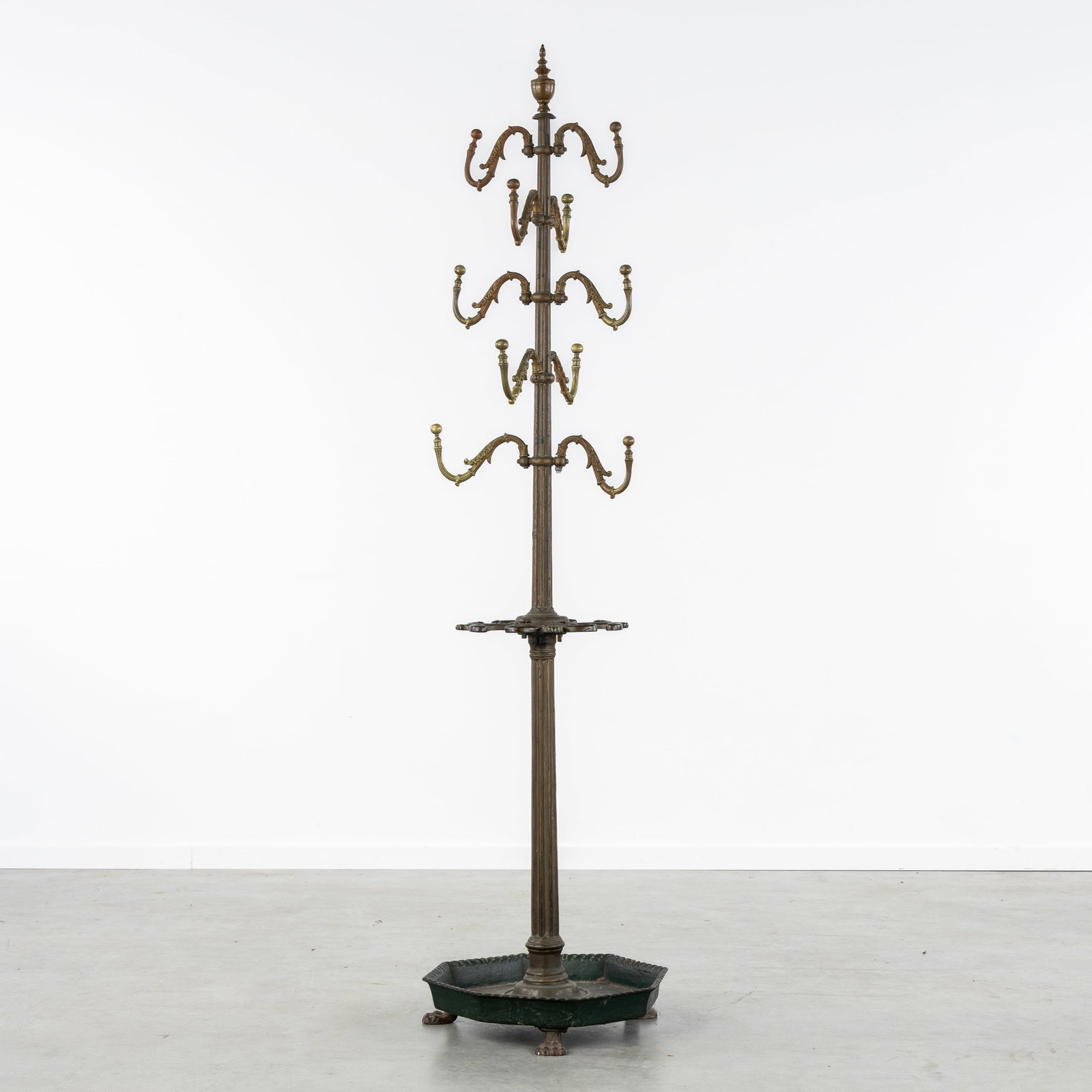 A Large coat rack with umbrella holder, patinated cast iron and bronze.: A Large coat rack with umbrella holder, patinated cast iron and bronze. Green patinated cast iron and bronze.With umbrella holder and five two-arm coat rack levels.Mounted on lion's paws. Dimensi