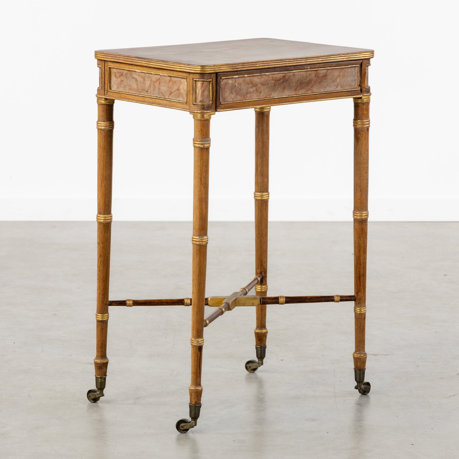 A Victorian side table on casters, faux bamboo and faux marble decor, England, late 19th C. (1 of 9)