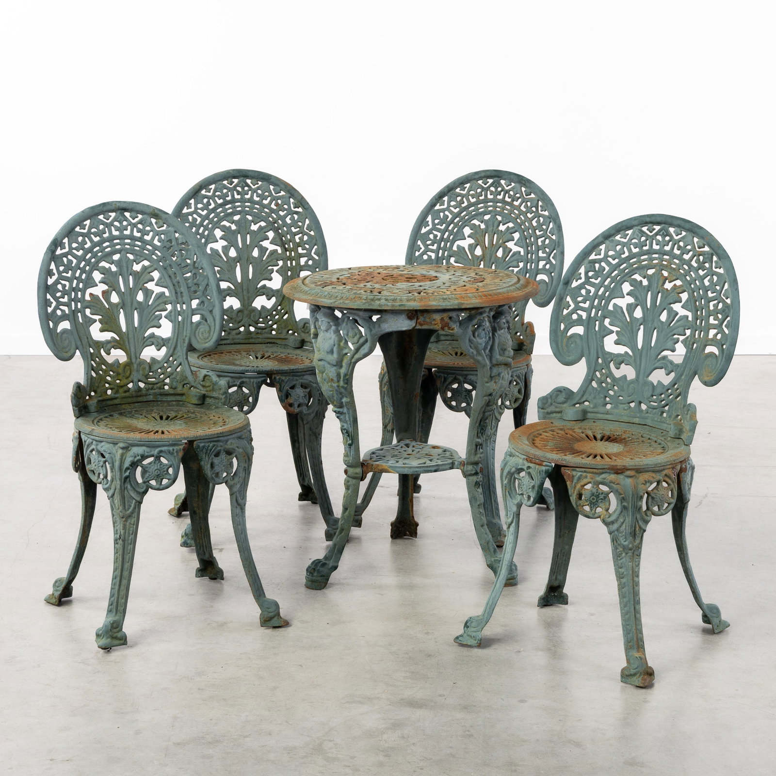 A Five-piece garden set, four chairs and a table, patinated cast iron, circa 1970. (1 of 8)