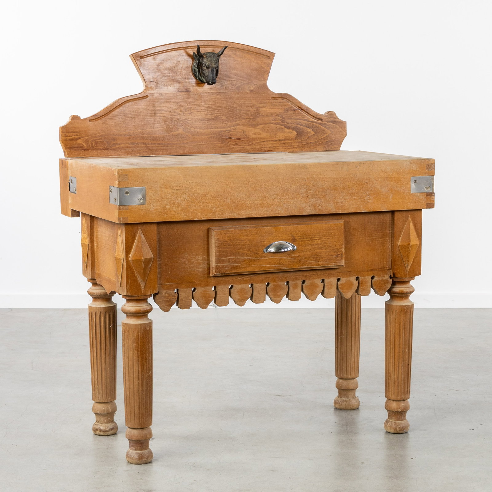 A Chopping block or butcher's table, with a drawer and knife slot, finished with a bull's head. (1 of 8)