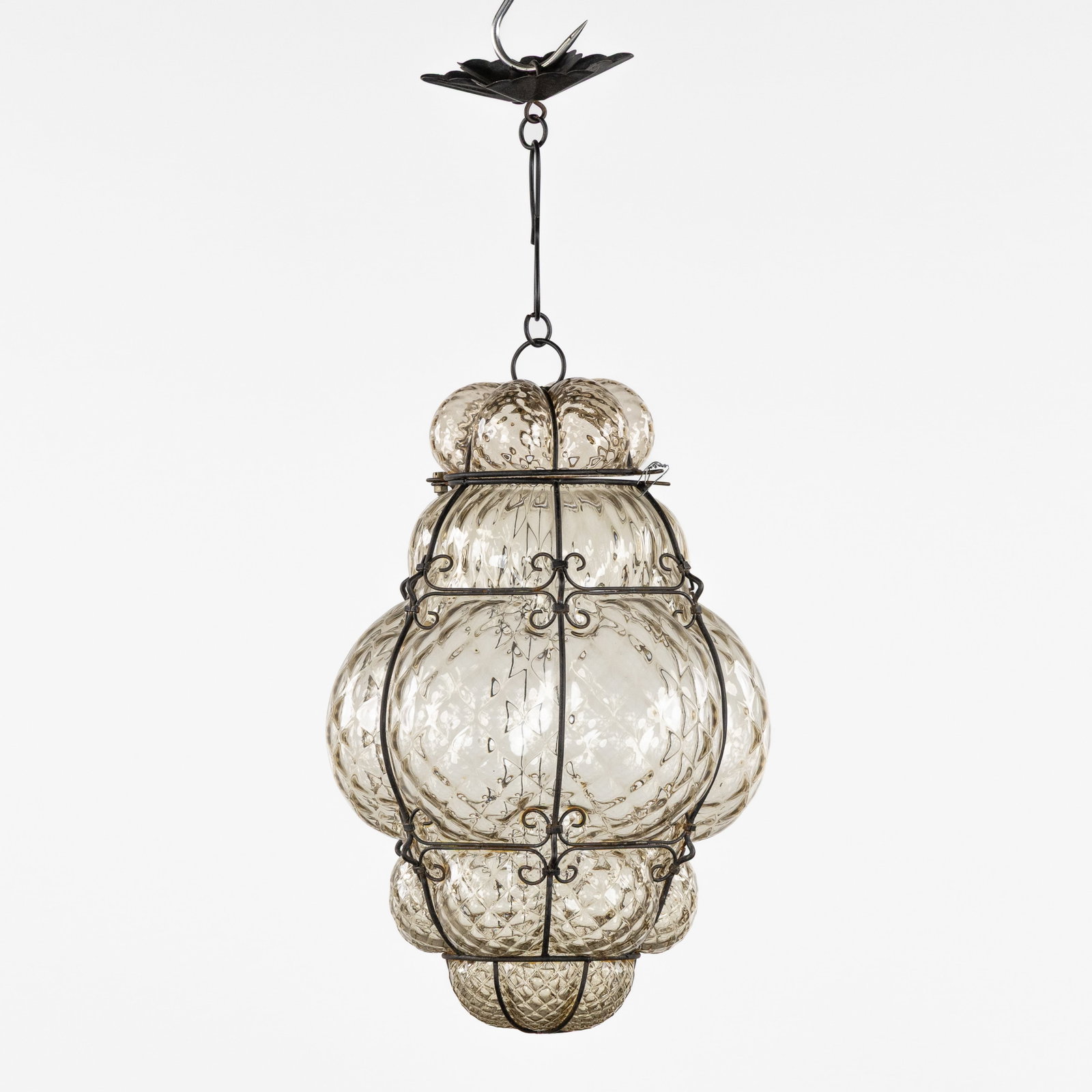 A Venetian lantern or hall lamp, blown glass in a metal frame, Murano, Italy.: A Venetian lantern or hall lamp, blown glass in a metal frame, Murano, Italy. Height including the chain: 46 cm. Dimensions: (W:23 x H:38 cm) The absence of a condition report does not imply a perfect