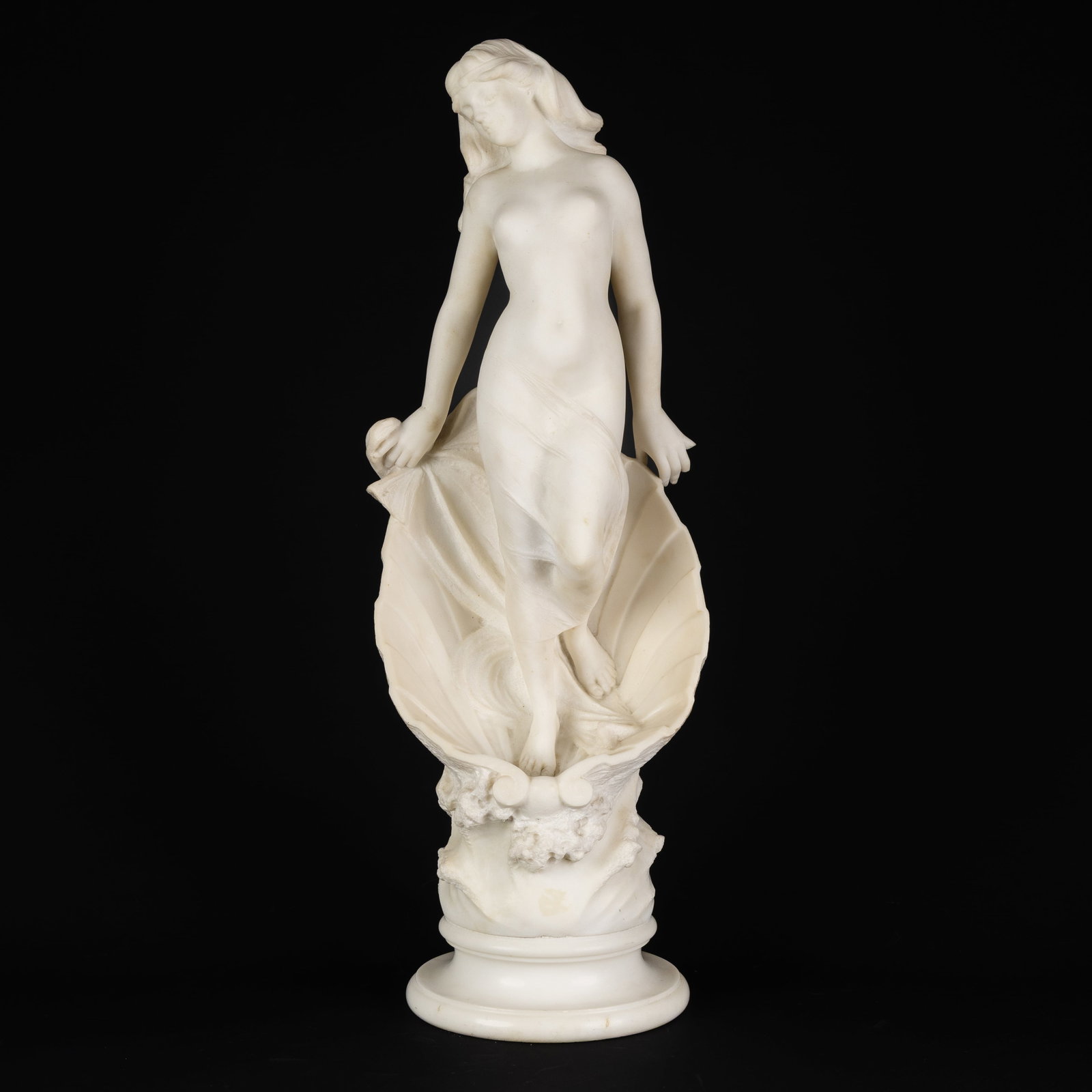 Eugenio Battiglia (XIX-XX) 'The Birth of Venus', a Carrara marble sculpture, Florence, circa 1900.: Eugenio Battiglia (XIX-XX) 'The Birth of Venus', a Carrara marble sculpture, Florence, circa 1900. Sculptured in Carrara marble.Depiction of a nude Venus, standing in a shell.Signed 'E. Battiglia, Flo