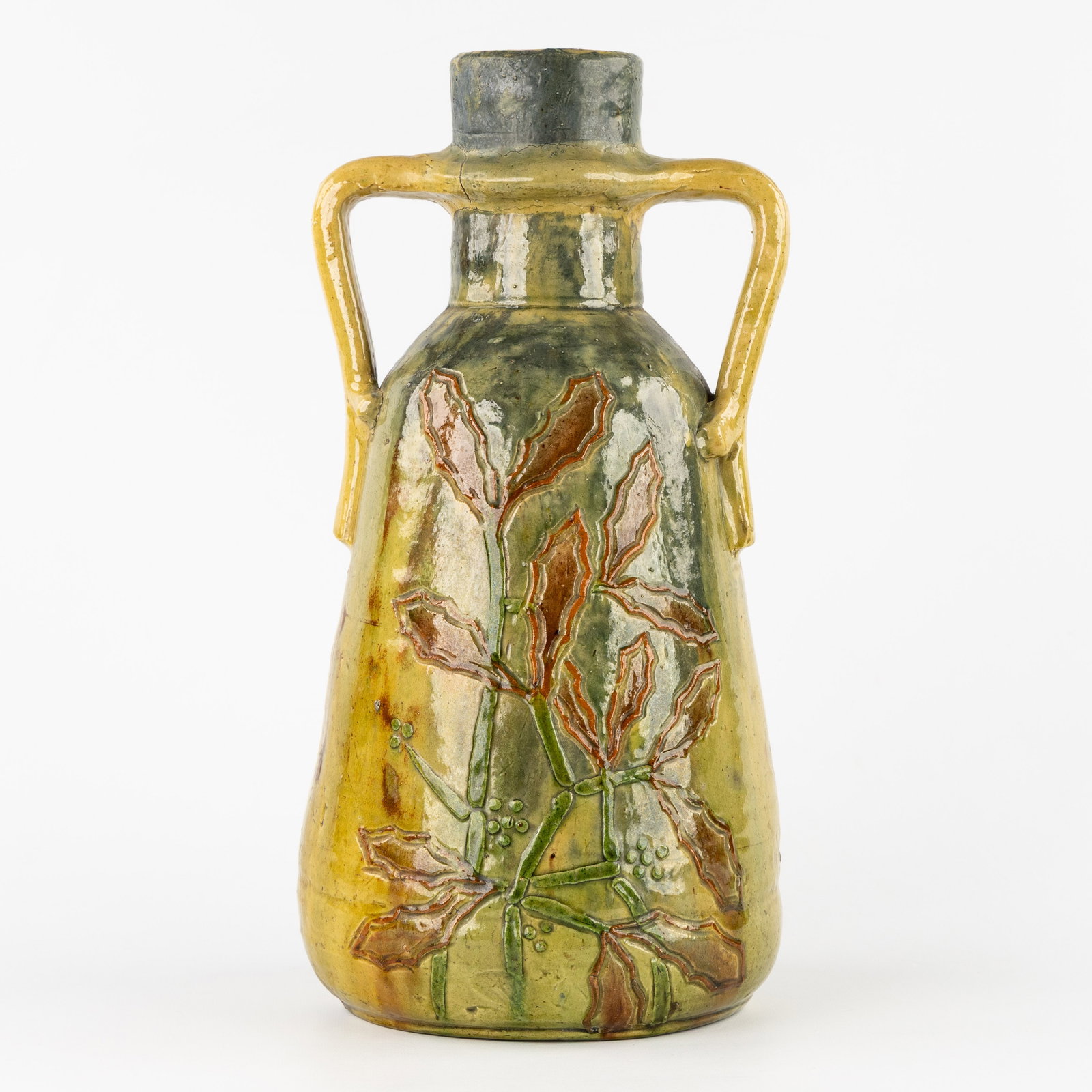 Leo Maes-Vereenooghe (XIX-XX) a vase - 'Holly' decoration, glazed ceramic. Flemish Earthenware,: Leo Maes-Vereenooghe (XIX-XX) a vase - 'Holly' decoration, glazed ceramic. Flemish Earthenware, Torhout. A vase with 'Holly' decoration.Glazed ceramicTorhout, Flemish Earthenware.Signed LMV. Dimension