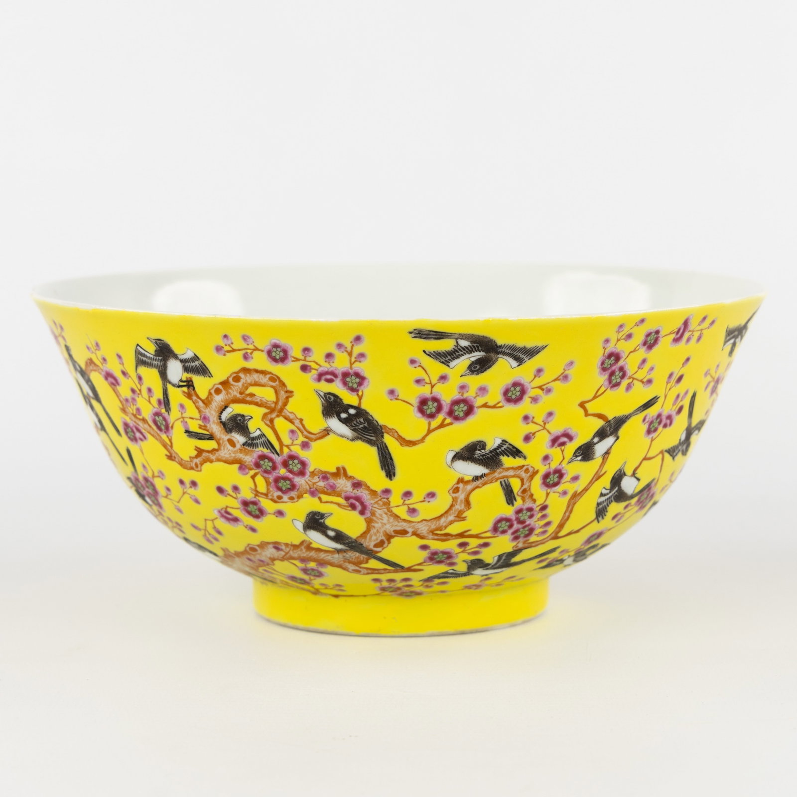 A large Chinese bowl, yellow ground with 'Magpies and Prunus' decor, Tongzhi mark.: A large Chinese bowl, yellow ground with 'Magpies and Prunus' decor, Tongzhi mark. Marked on the base, Tongzhi. Dimensions: (W:21 x H:9,5 cm) Condition: In our opinion in good condition. No hairline c