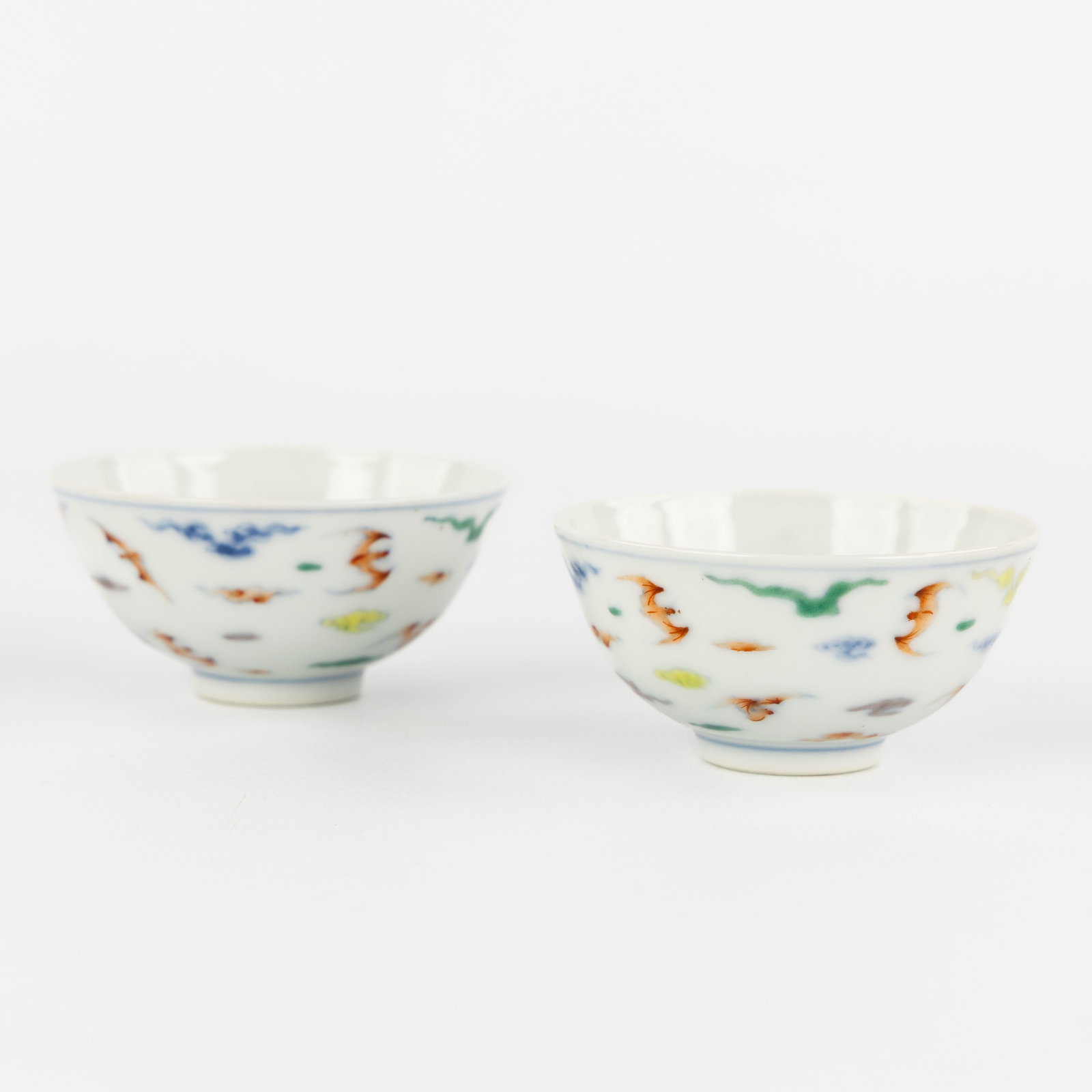 A pair of small Chinese teacups with bat decoration, marked Yongzheng. (1 of 5)