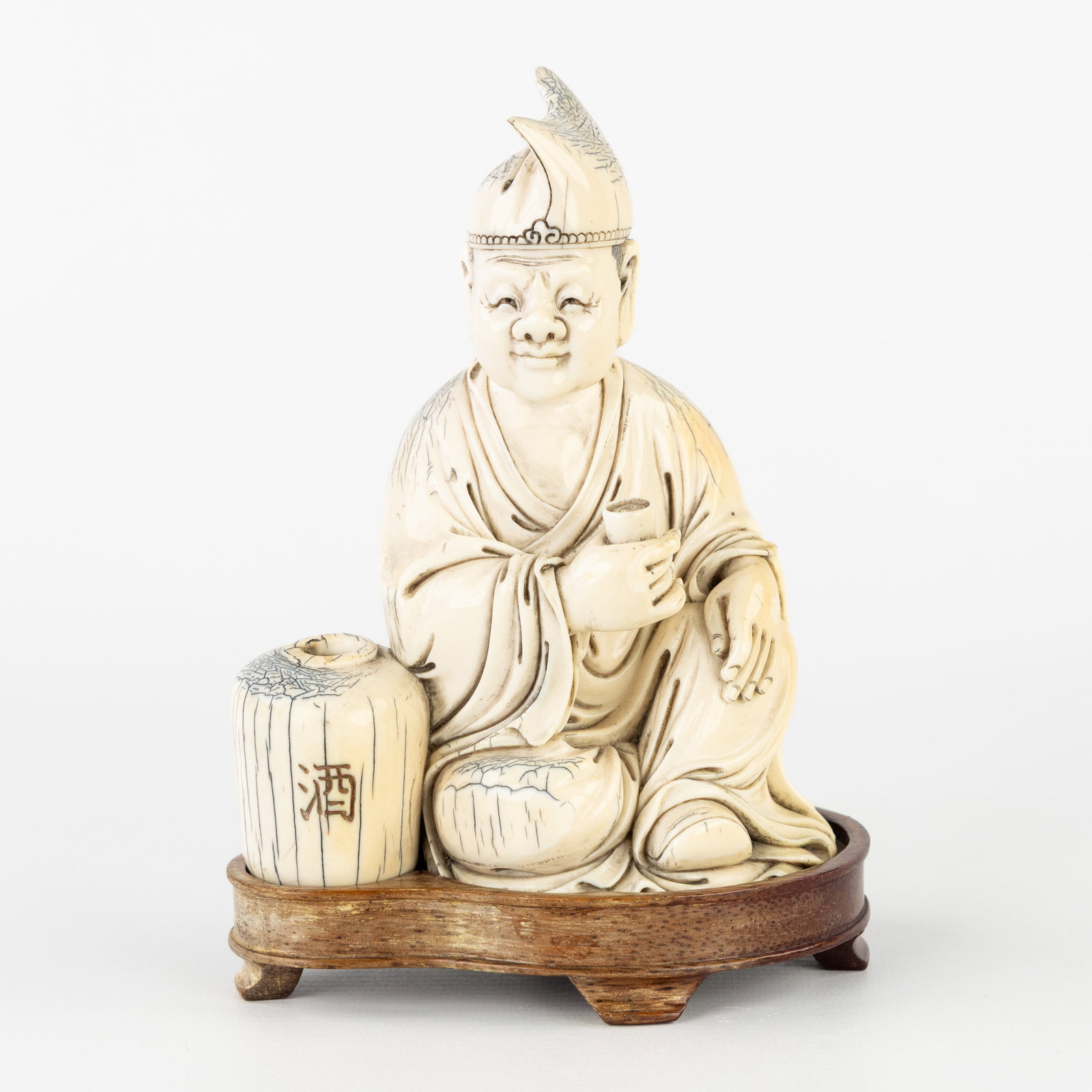 A Japanese Okimono of a Man with a Sake Jug, sculptured mammoth ivory, Japan, Meiji. (1 of 7)