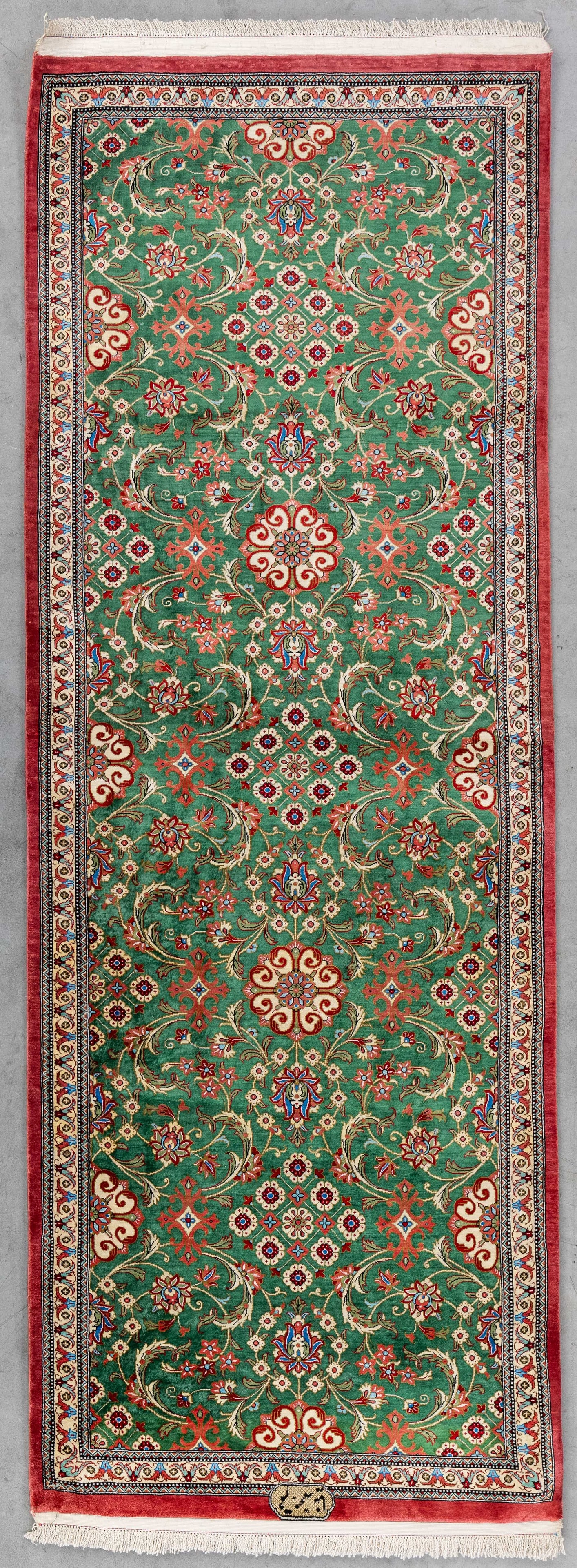 An Oriental hand-made carpet, Silk, Ghoum, Iran (168 x 60,5 cm).: An Oriental hand-made carpet, Silk, Ghoum, Iran (168 x 60,5 cm). Signed. Dimensions: (W:60,5 x H:168 cm) The absence of a condition report does not imply a perfect item. Please send us an e-mail to re