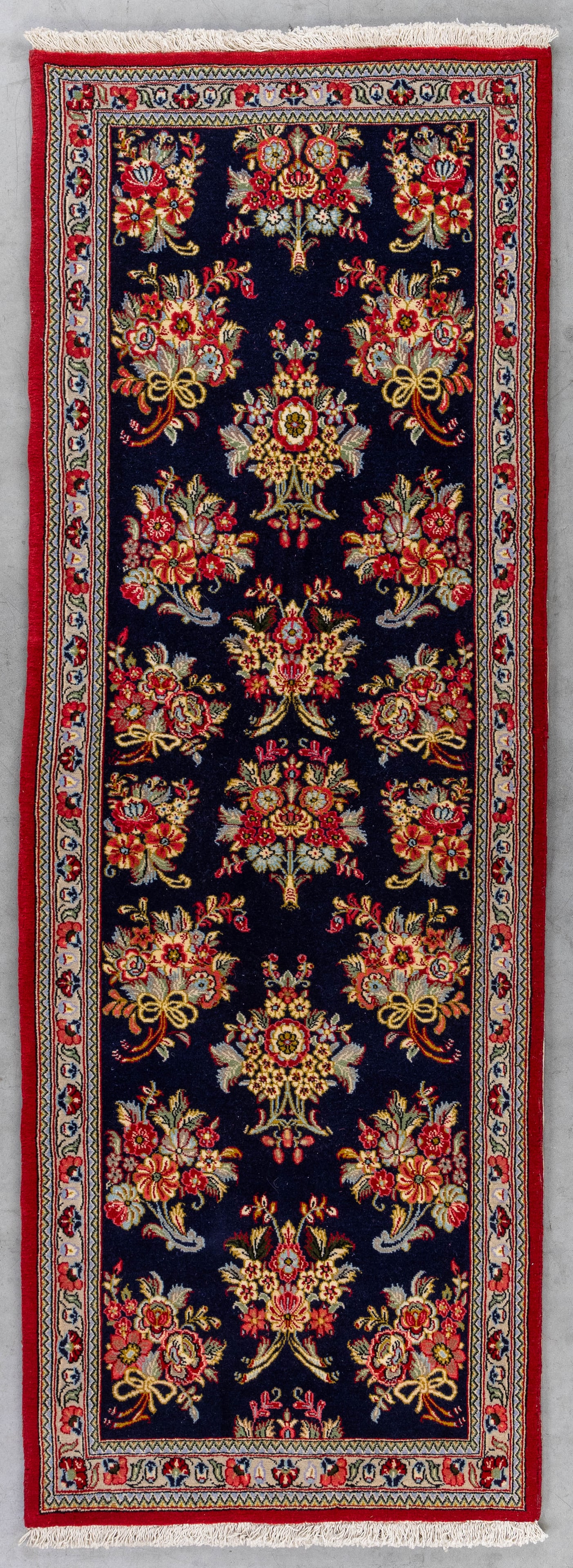 An Oriental hand-made carpet, Ghoum, Iran (198 x 70 cm).: An Oriental hand-made carpet, Ghoum, Iran (198 x 70 cm). Dimensions: (W:70 x H:198 cm) The absence of a condition report does not imply a perfect item. Please send us an e-mail to request a condition 