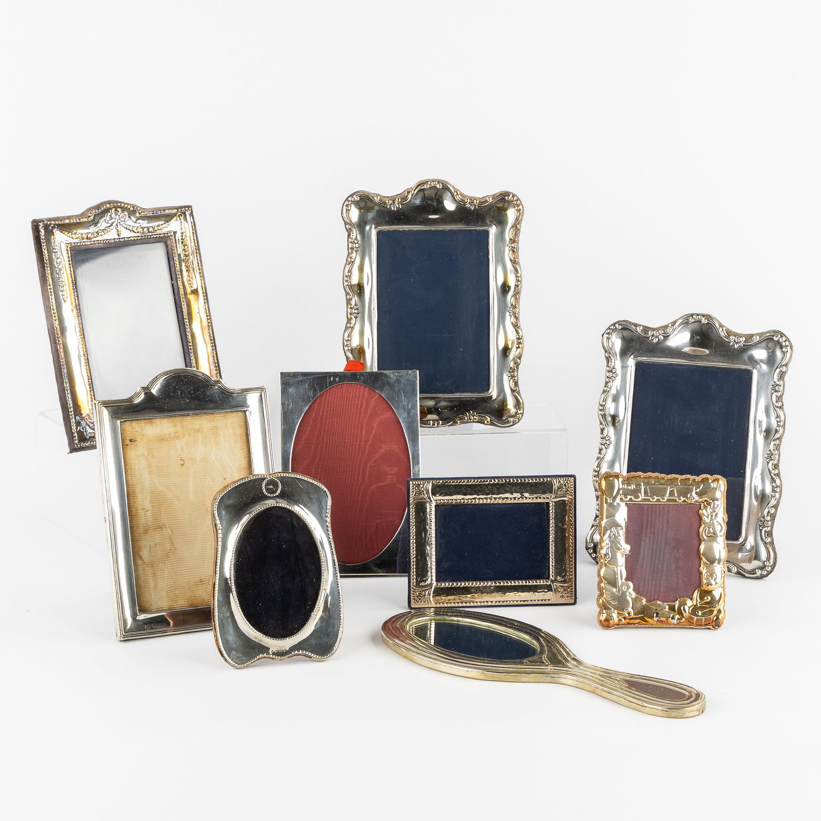 Seven silver photo frames, one silver-plated photo frame and a mirror. England and Italy, 20th centu (1 of 9)