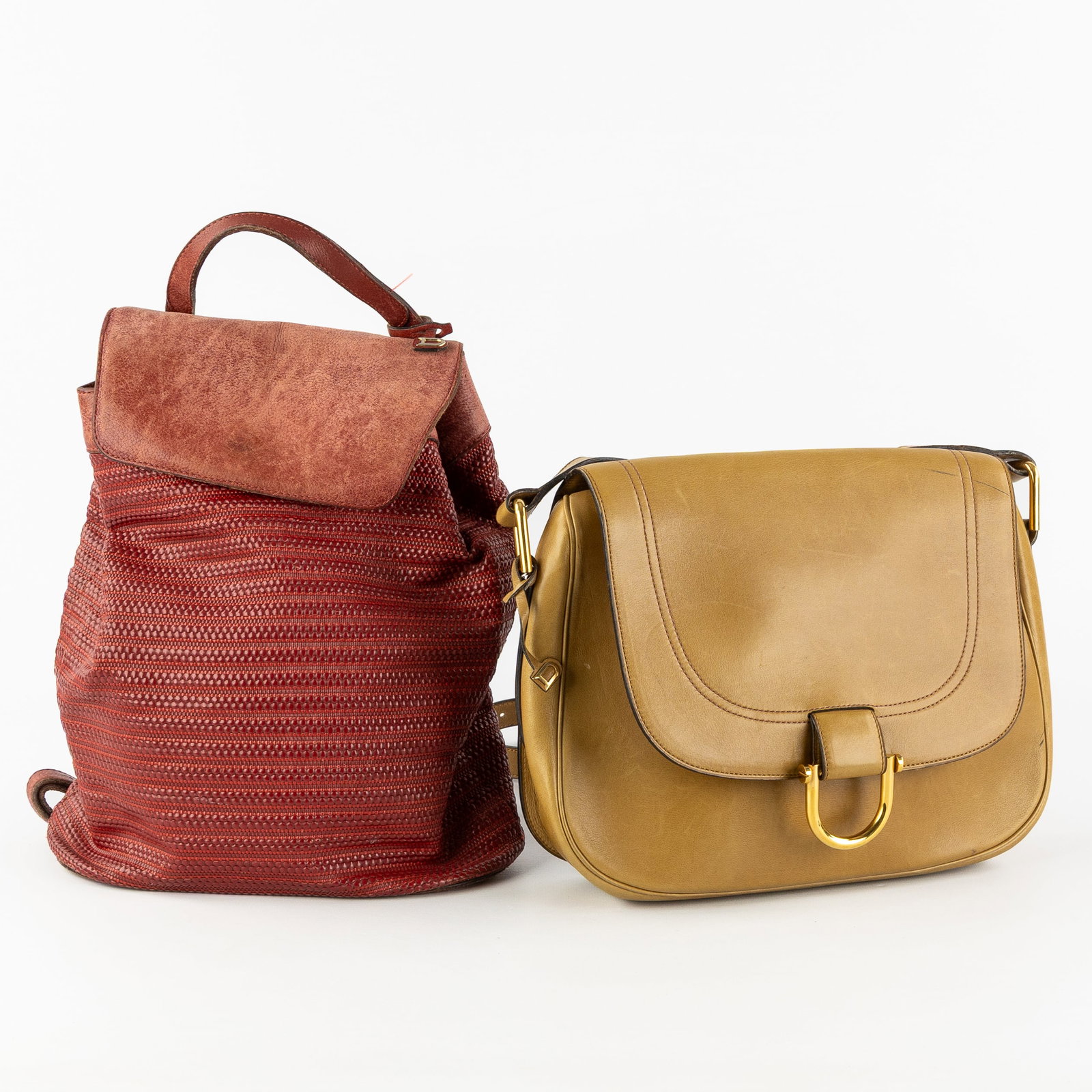 Delvaux, a vintage crossbody handbag in ochre leather, and a Tissage Côtelé Antilles backp: Delvaux, a vintage crossbody handbag in ochre leather, and a Tissage Côtelé Antilles backpack in burgundy red leather. Vintage crossbody handbag.Ochre-coloured leather and gold-plated hardwa
