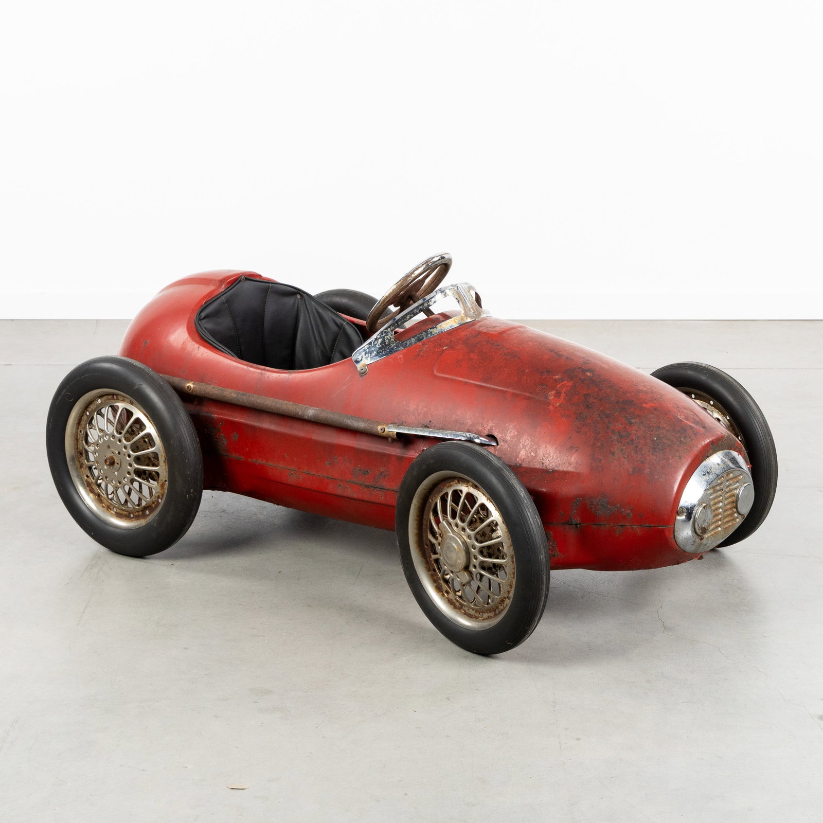 A Vintage Ferrari 500 F2 pedal car, patinated and chromed metal, Giordani, circa 1950-1960.: A Vintage Ferrari 500 F2 pedal car, patinated metal, Giordani, circa 1950-1960. Red patinated and chrome-plated metaal.Hard rubber tires and faux leather seat.Design inspired by the famous Ferrari 5