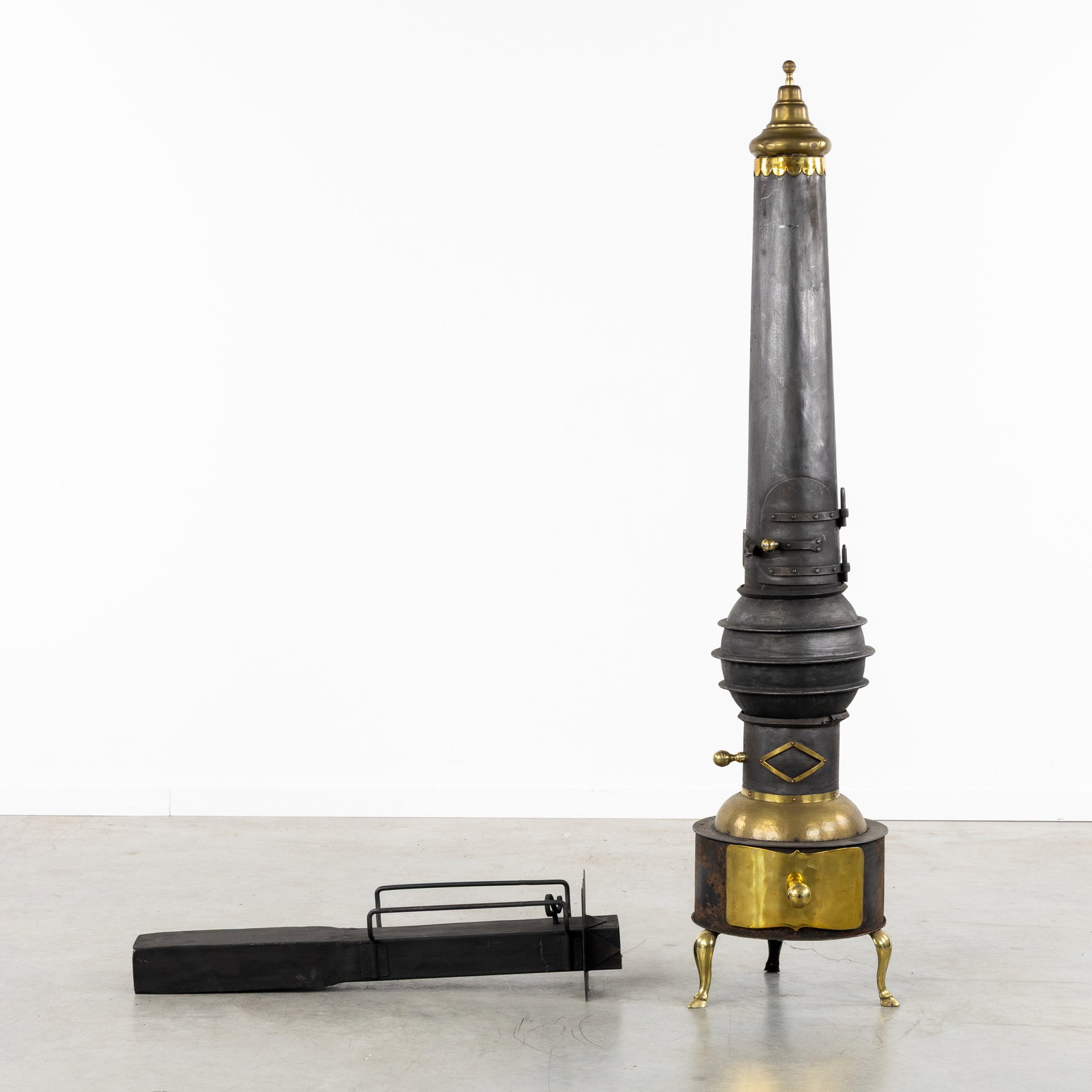 Frans Wiro van Hinsberg (1906-1986) a decorative stove, brass and wrought iron, Damme, Belgium,: Frans Wiro van Hinsberg (1906-1986) a decorative stove, brass and wrought iron, Damme, Belgium, circa 1950-1960. Patinated wrought iron and brass.Elongated stove with rectangular flue (12 x 7 cm), wit