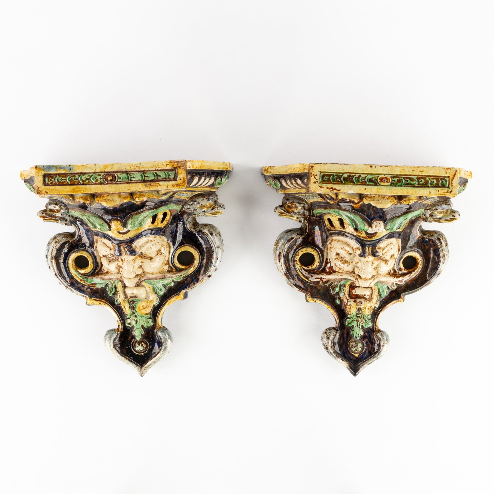 A pair of majolica wall consoles in the shape of mascarons or grotesques. Renaissance style, (1 of 11)