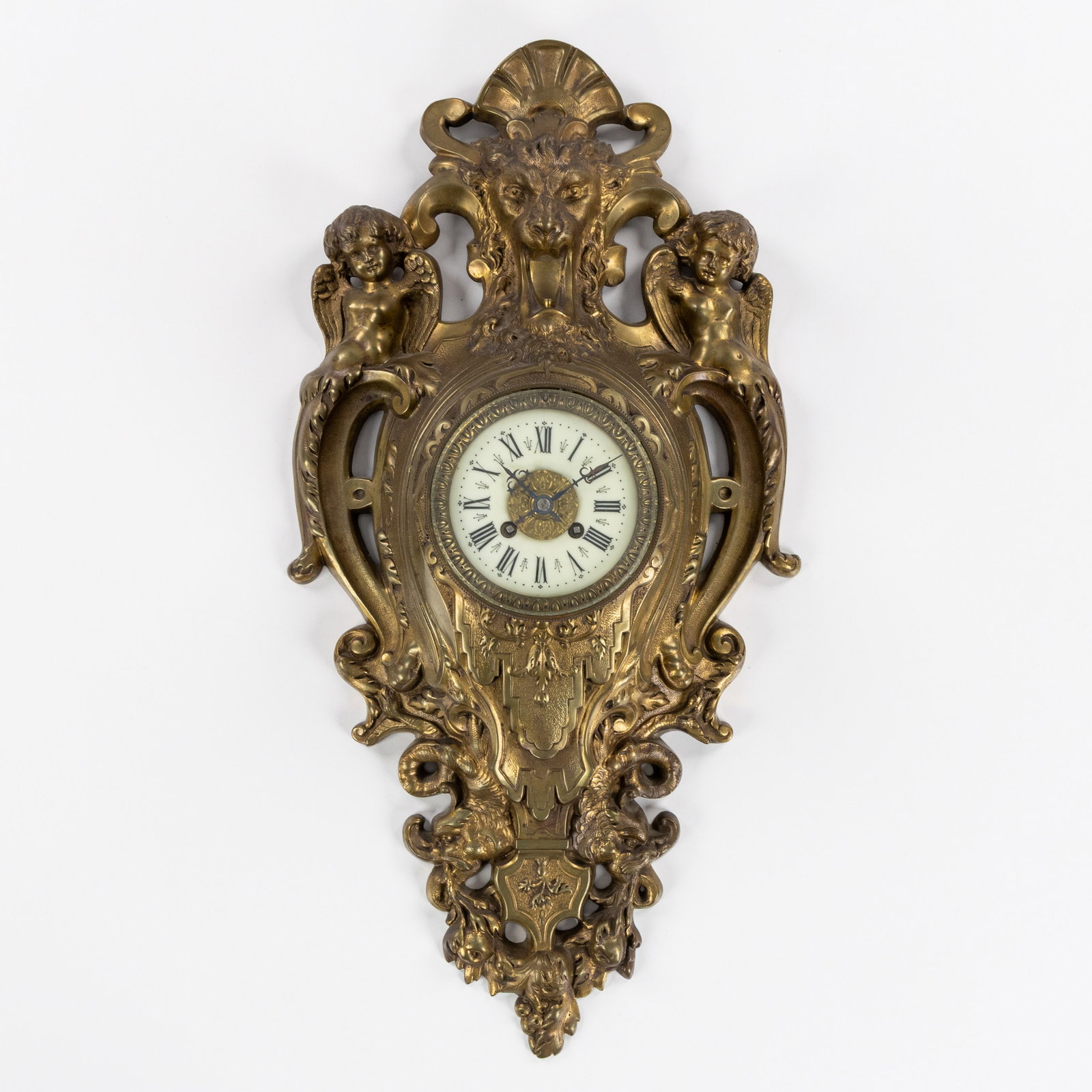 A Bronze wall clock, decorated with a Lion's head and Putti, France, 19th C. (1 of 7)