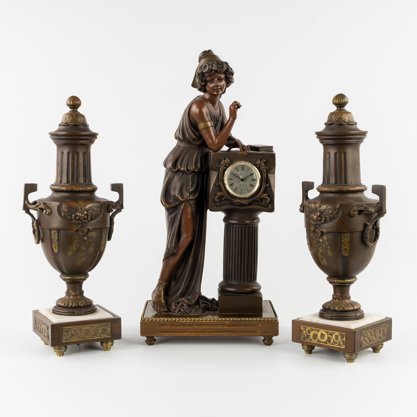 A three-piece mantel garniture, clock and matching decorative vases, patinated resin and marble. (1 of 8)