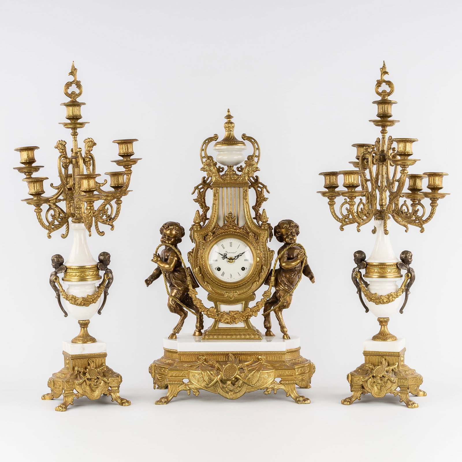 A Three-piece mantel garniture, clock and candelabra, mounted with Fauns, gilded bronze and marble, (1 of 13)