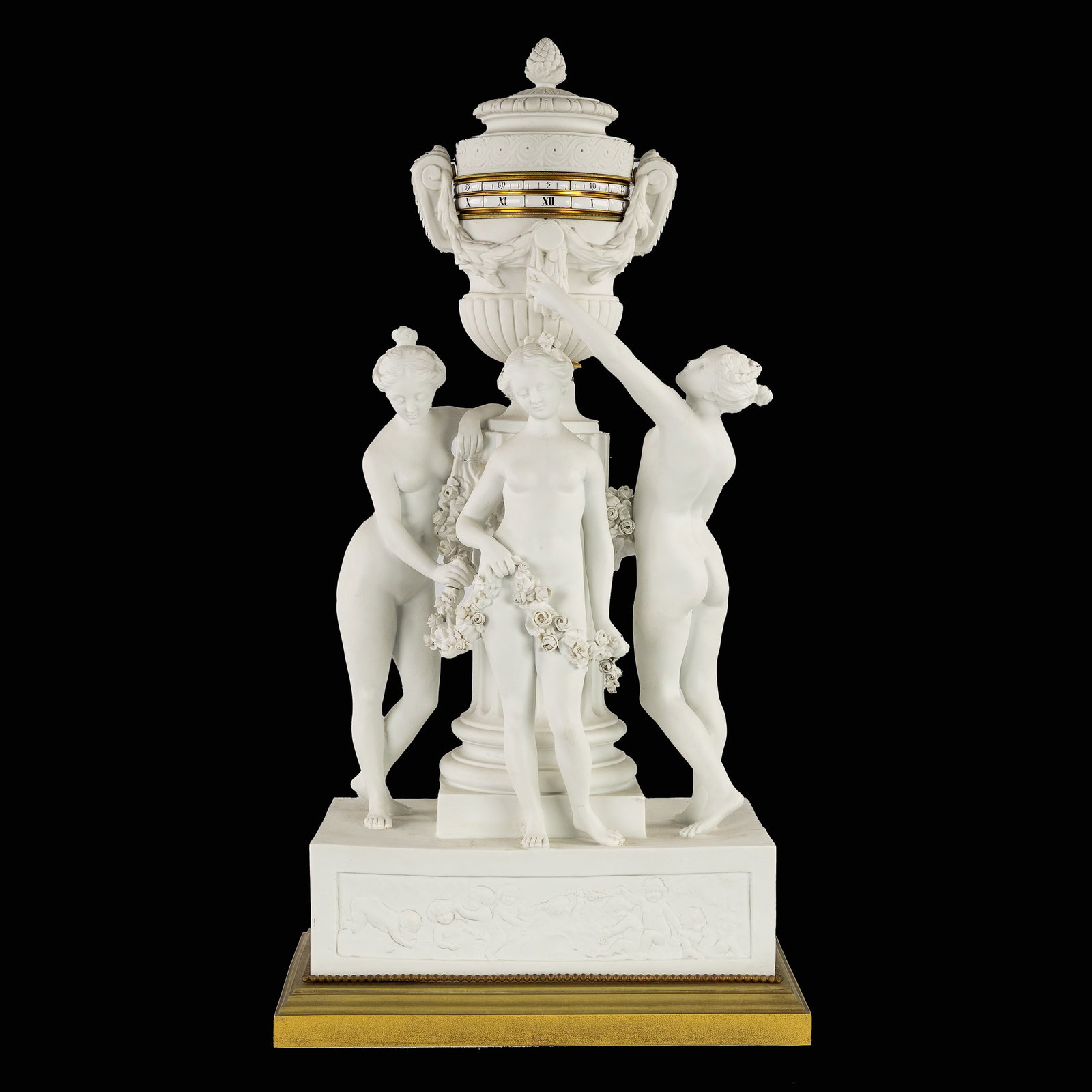 After Etienne Falconet (1716-1791) A Sèvres biscuit 'Pendule à Cercles Tournants',: After Etienne Falconet (1716-1791) A Sèvres biscuit 'Pendule à Cercles Tournants', decorated with the Three Graces. 19th century. Biscuit porcelain.A clock with rotating cylindrical dials or