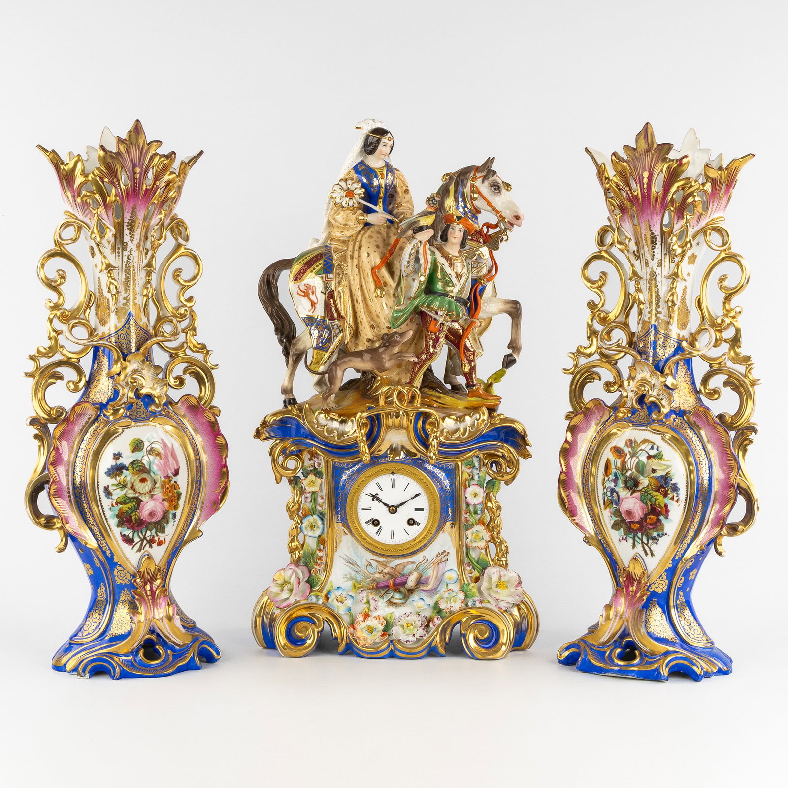 Vieux Paris, a three-piece mantel garniture, 'Mary of Burgundy on Horseback with Falconer', after: Vieux Paris, a three-piece mantel garniture, 'Mary of Burgundy on Horseback with Falconer', after Jacob Petit, France, 19th century. Polychrome porcelain, with gilded finish. Three-piece mantel garnit