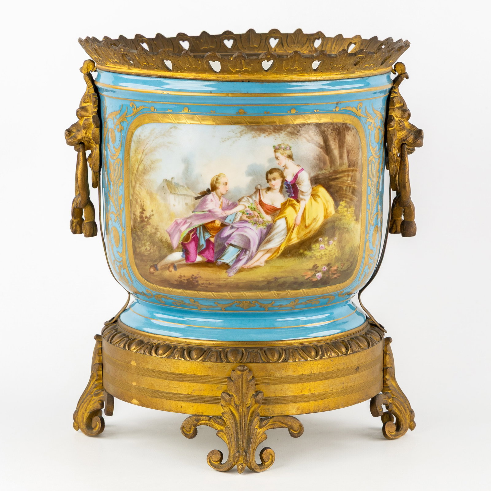 Sèvres, a Cache-pot or Vase, 'Bleu Céleste' porcelain, mounted with gilded bronze and lion: Sèvres, a Cache-pot or Vase, 'Bleu Céleste' porcelain, mounted with gilded bronze and lion heads. Bleu Céleste porcelain.Decorated with romantic scene and floral decor, gilded finish.
