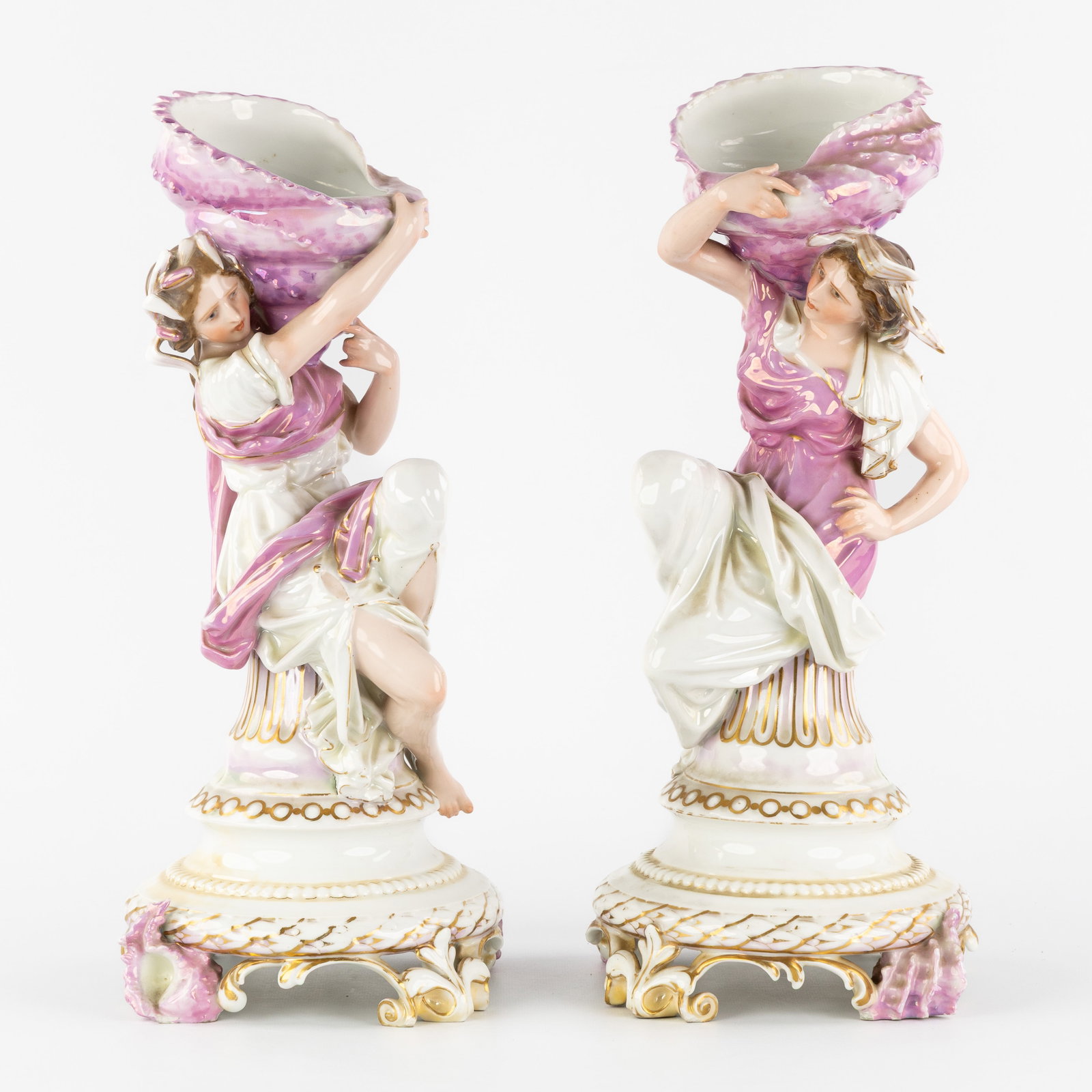 Gillet & Brianchon, A Pair of porcelain figurines, 'Lady with Shell', Paris, France, 19th century.: Gillet & Brianchon, A Pair of porcelain figurines, 'Lady with Shell', Paris, France, 19th century. Polychrome porcelain, mother-of-pearl glaze.Depicting a seated lady with a large shell on her sho