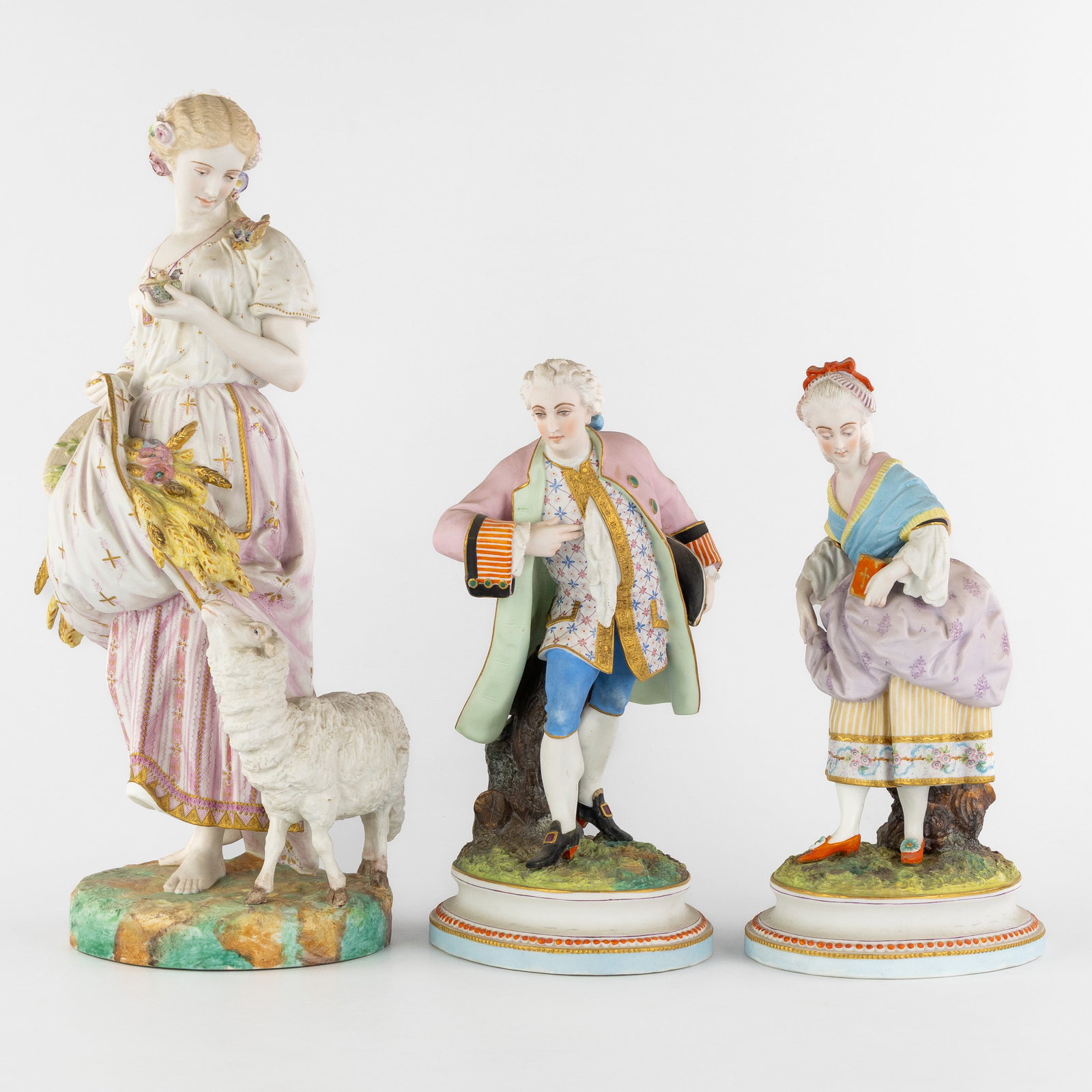 Vion & Baury, a statue 'The Harvest', added are a Noble Man and Woman, Polychrome biscuit porcelain.: Vion & Baury, a statue 'The Harvest', added are a Noble Man and Woman, Polychrome biscuit porcelain. 19th century. A large biscuit porcelain figurine 'The Harvest'. Depicting a lady holding whea